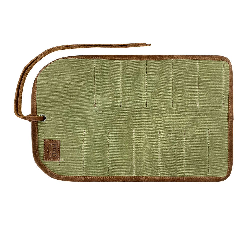 Hide & Drink Tool Roll features a stylish small tool roll-up bag with 10 slots, created from fine full grain leather. This portable carry-on pouch is perfect for woodworking tools organization, enhancing your workshop storage experience. Each handmade product reflects artisan craftsmanship from La Antigua Guatemala & Oaxaca Mexico.