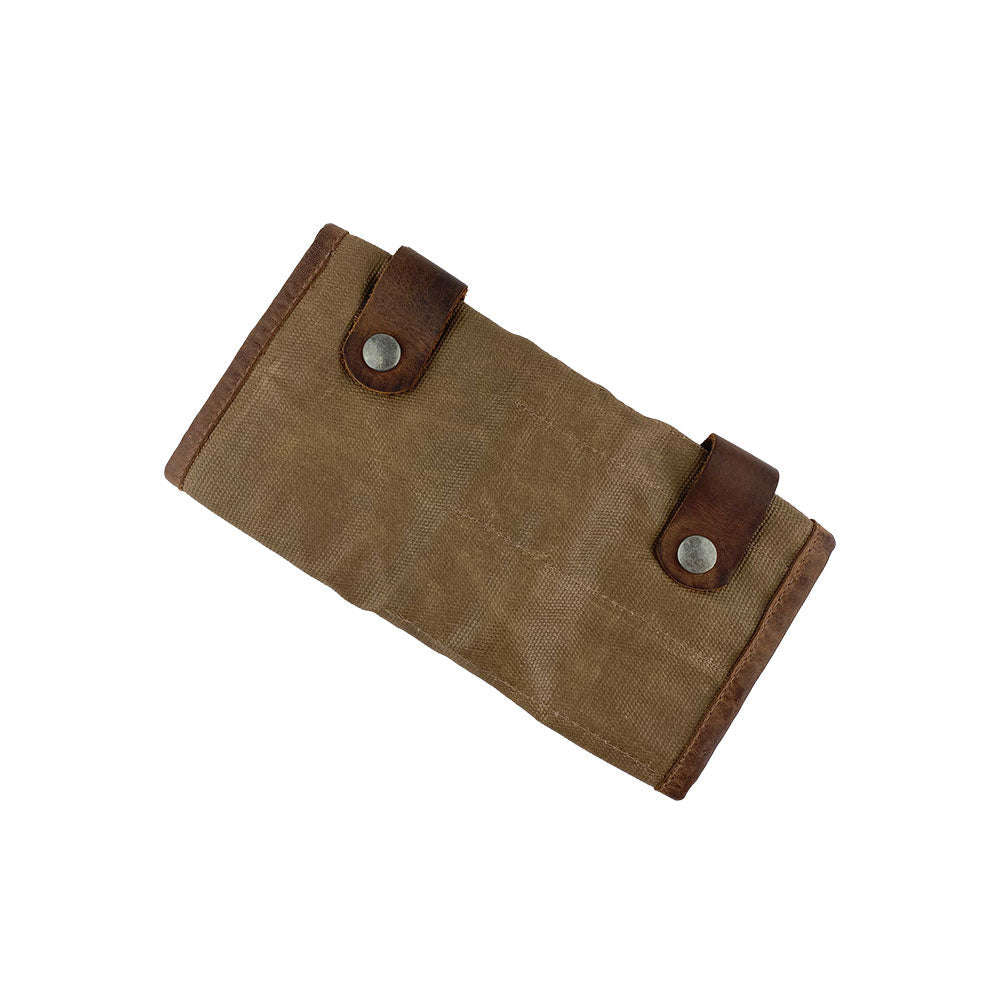 Folded view of Hide & Drink's Barber Tool Roll, a stylish Snap Tool Roll Up Bag with 14 Slots perfect for scissors & screwdrivers. Made from high-quality Full Grain Leather, this portable carry case aligns with StockyardX's dedication to small batch production and artisan craftsmanship, hand cut, hand sewn, and fire branded in La Antigua Guatemala & Oaxaca Mexico.