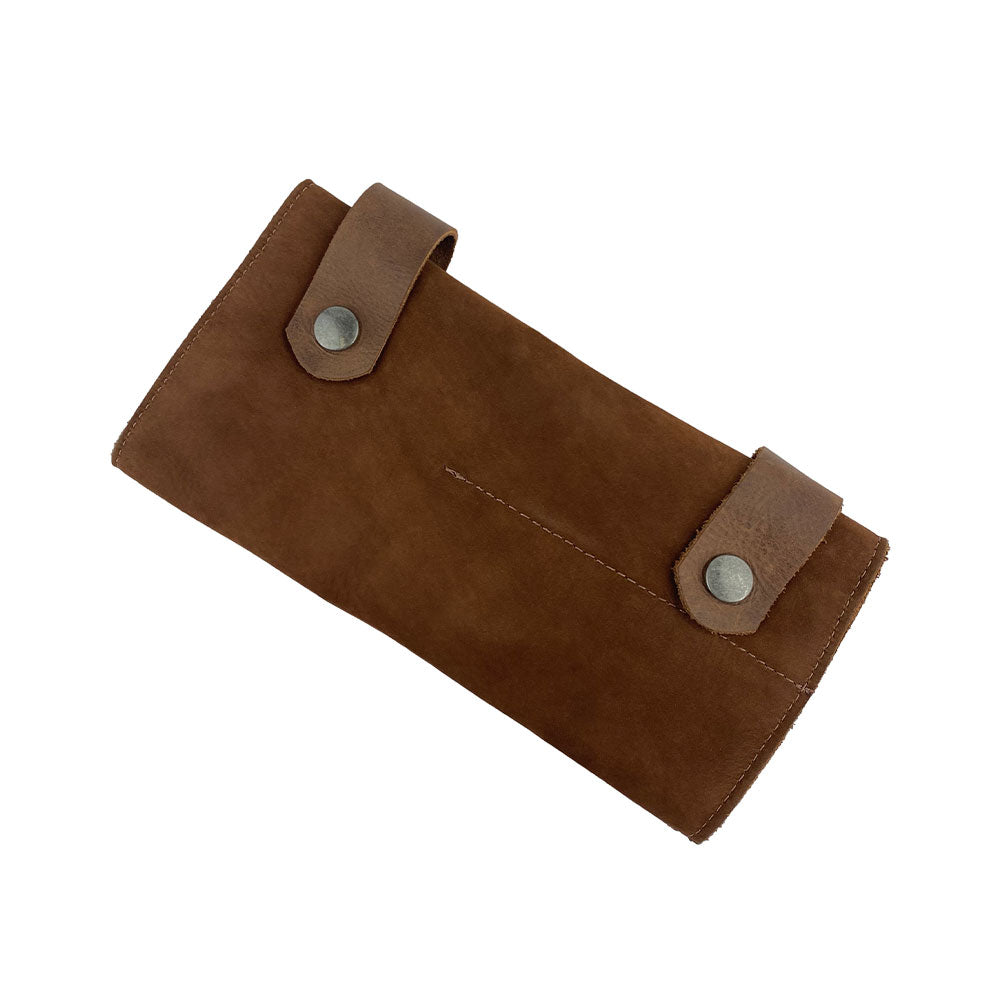 Folded view of Hide & Drink's Barber Tool Roll, a stylish Snap Tool Roll Up Bag with 14 Slots for scissors & screwdrivers. This portable carrying solution is made from high-quality Full Grain Leather and celebrates StockyardX's commitment to small batch production and artisan craftsmanship, hand cut, hand sewn, and fire branded in La Antigua Guatemala & Oaxaca Mexico.