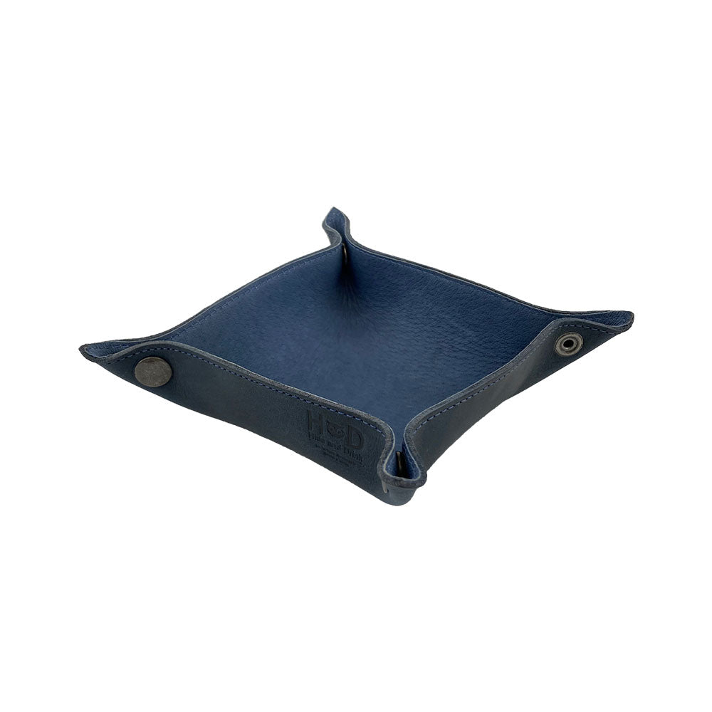 Side view of the Valet Tray with Sheep Skin by Hide & Drink, highlighting its rustic brass hardware and beautiful leather texture. This versatile storage valet works great as a tray for personal items and adds a touch of elegance to any decor. An essential handmade item from small batch production, crafted from Full Grain Leather & Sheepskin and fire branded in La Antigua Guatemala & Oaxaca Mexico.