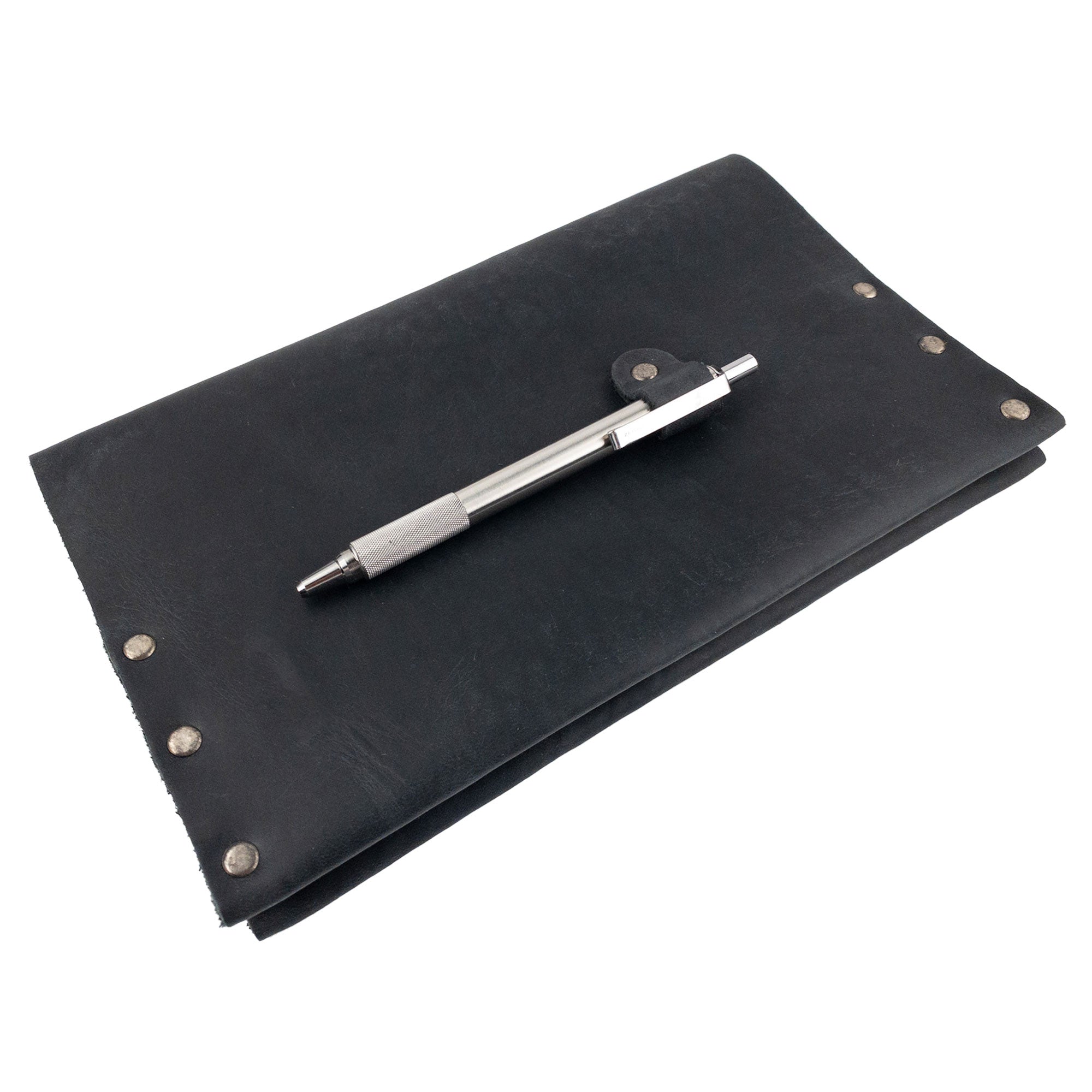 Hide & Drink's Riveted Journal Cover (5 x 8.50 in.) beautifully displayed with a pen, emphasizing its practical use and aesthetic appeal. Crafted from full grain leather, this classic sleeve is perfect for carrying notebooks and reflects small batch production and artisan quality. An essential item for anyone wanting the Riveted Journal Cover for Notebook (5 x 8.50 in.) (Notebook Not Included), merging functionality with style.