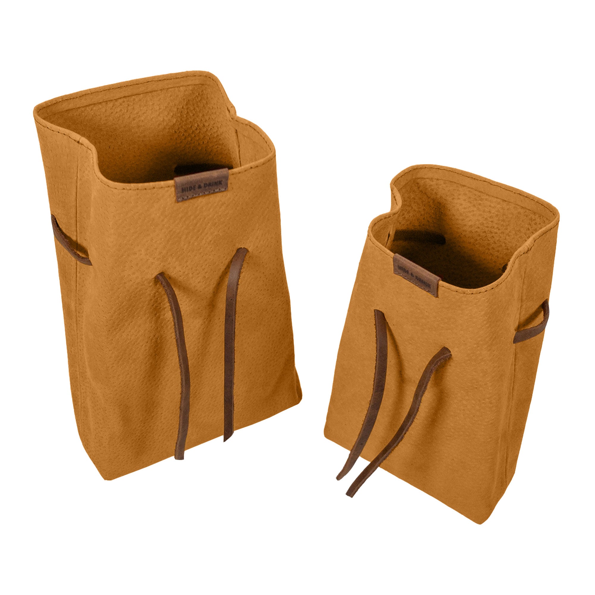 Displaying Hide & Drink's Drawstring Sack (2 pack) in use, elegantly filled with essential items for convenience. Drawstring Sack (2 pack) Handmade from Sheepskin and Full Grain Leather, StockyardX, Small Batch Production, Hand Cut, Hand Sewn, Fire Branded, Artisan, Handmade in La Antigua Guatemala & Oaxaca Mexico.