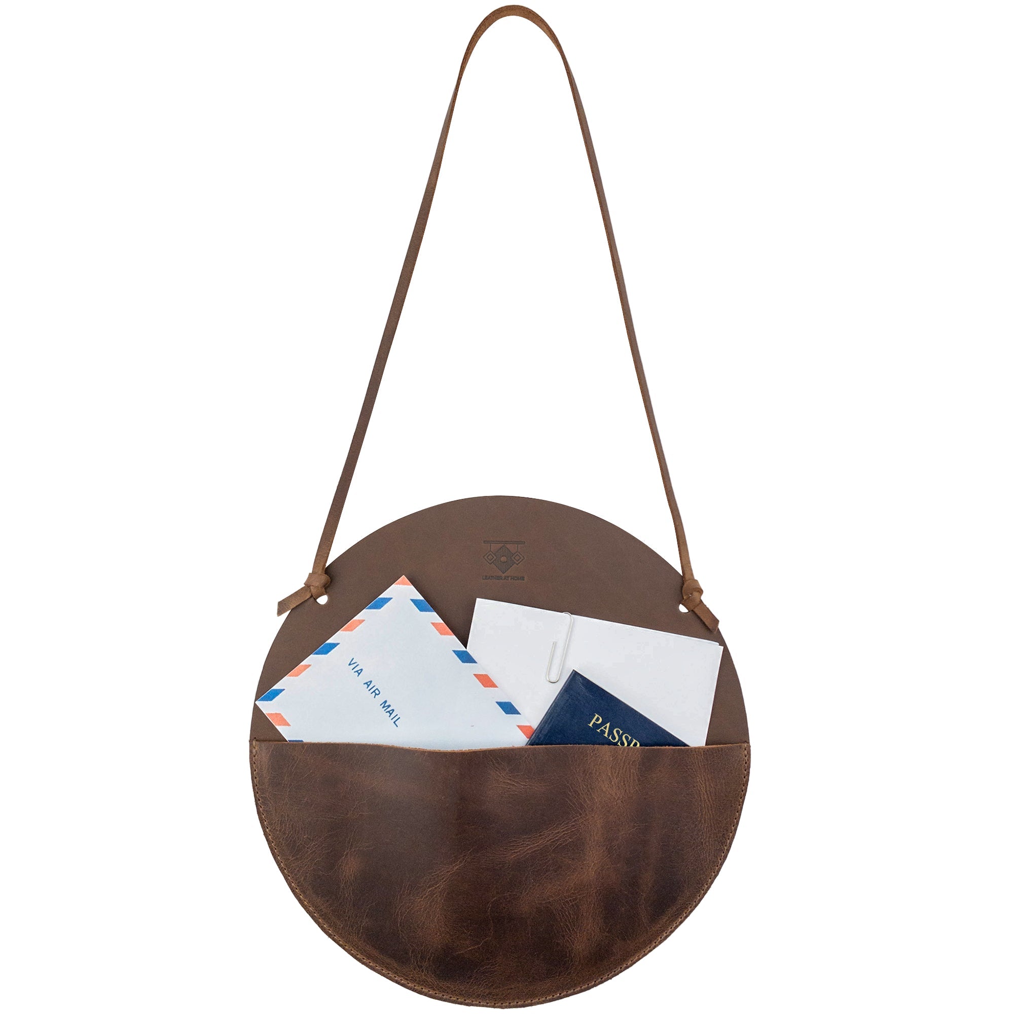 Leather At Home Circular Wall Hanger, filled with documents, letters, and envelopes. This wall file organizer is made from high-quality full grain leather, combining functionality and style in a handmade piece from La Antigua Guatemala.