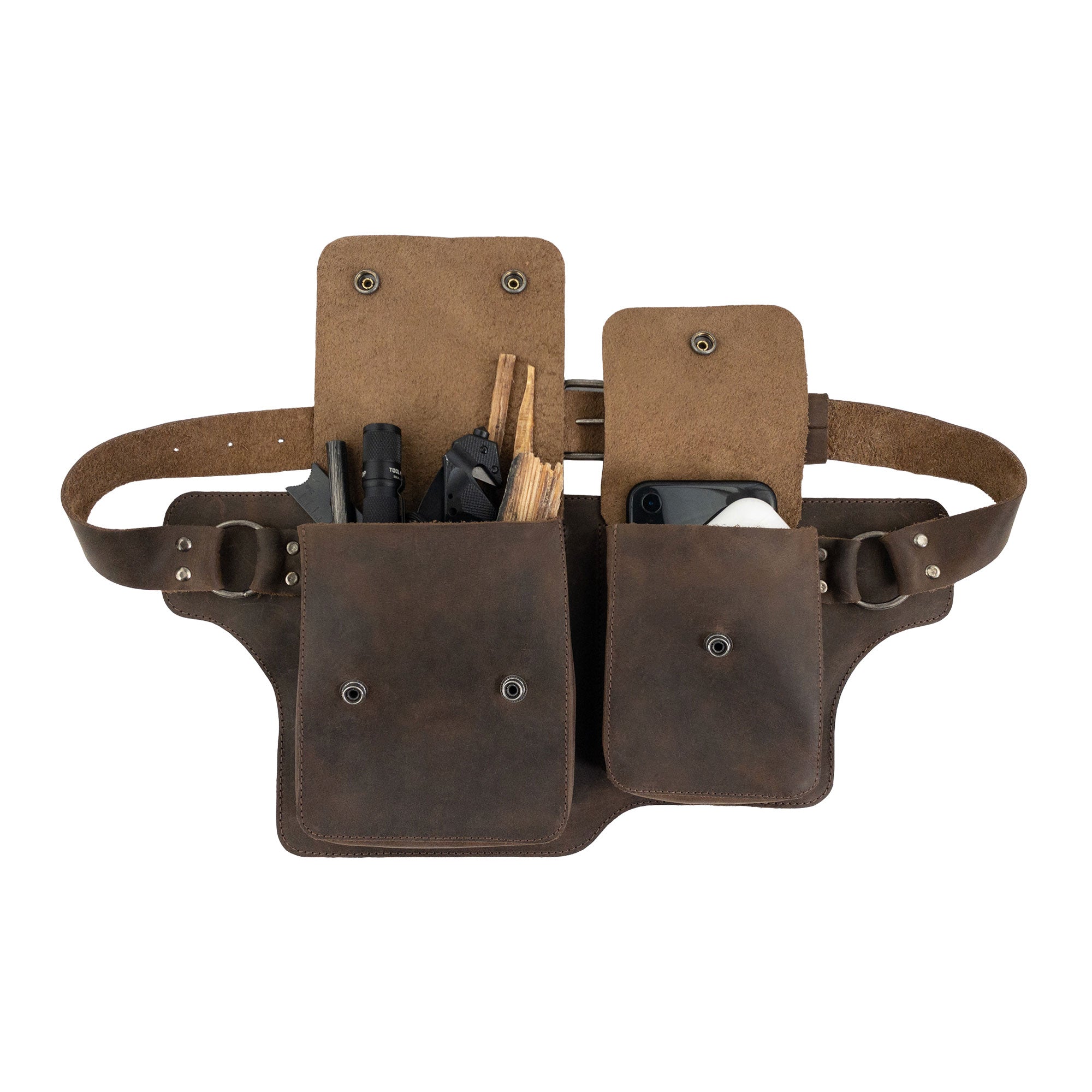 The Hide & Drink Rectangular Waist Bag filled with tools, emphasizing its practicality and rugged design made from Full Grain Leather. This Waist Bag with Adjustable Belt is perfect for outdoor enthusiasts, showcasing small batch production, artisan craftsmanship, and being handmade in La Antigua Guatemala & Oaxaca Mexico.