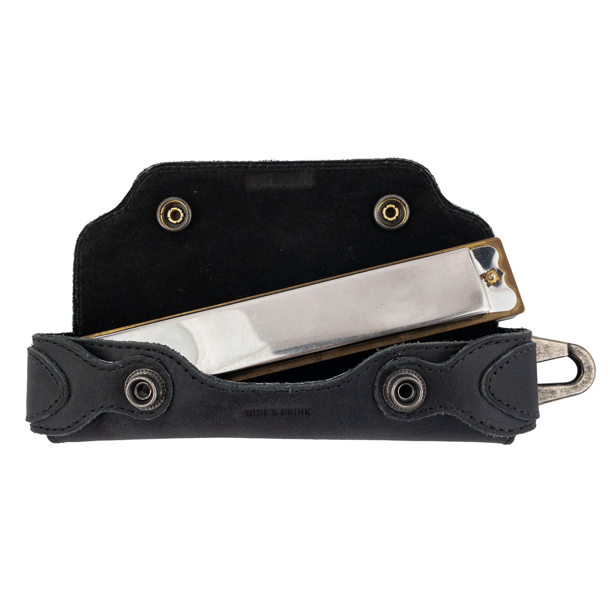 Harmonica Case by Hide & Drink with harmonica fitted inside, showcasing perfect protection. This full grain leather musician accessory is hand cut and sewn, embodying small batch production and quality craftsmanship from La Antigua Guatemala.