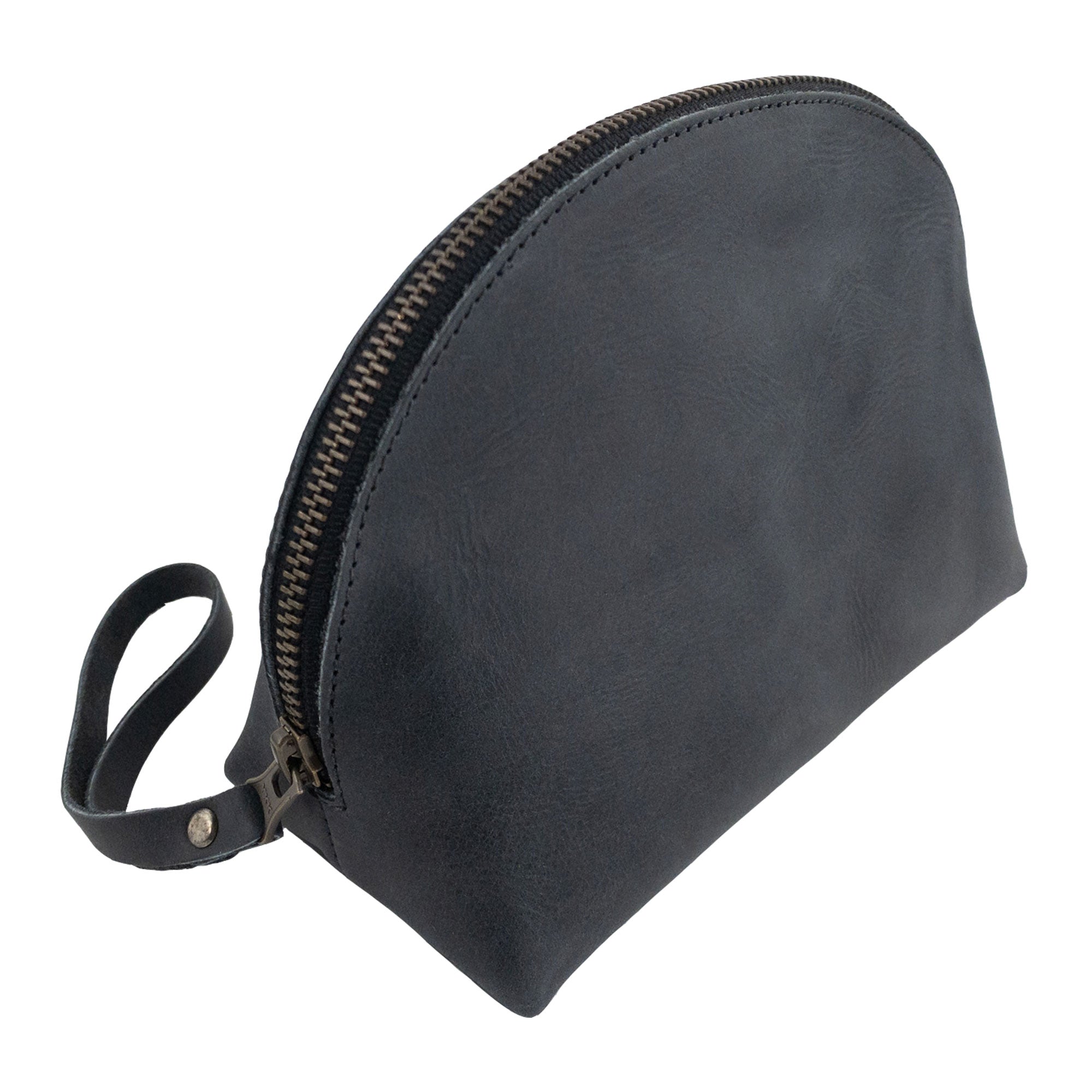 Side profile of the Accessory Pouch Organizer Hand Bag by Hide & Drink in beautiful black leather. This Cosmetic Travel Organizer with Hand Strap for Women doubles as a Makeup Bag and Classic Handbag, showcasing artisan craftsmanship from La Antigua Guatemala & Oaxaca Mexico.