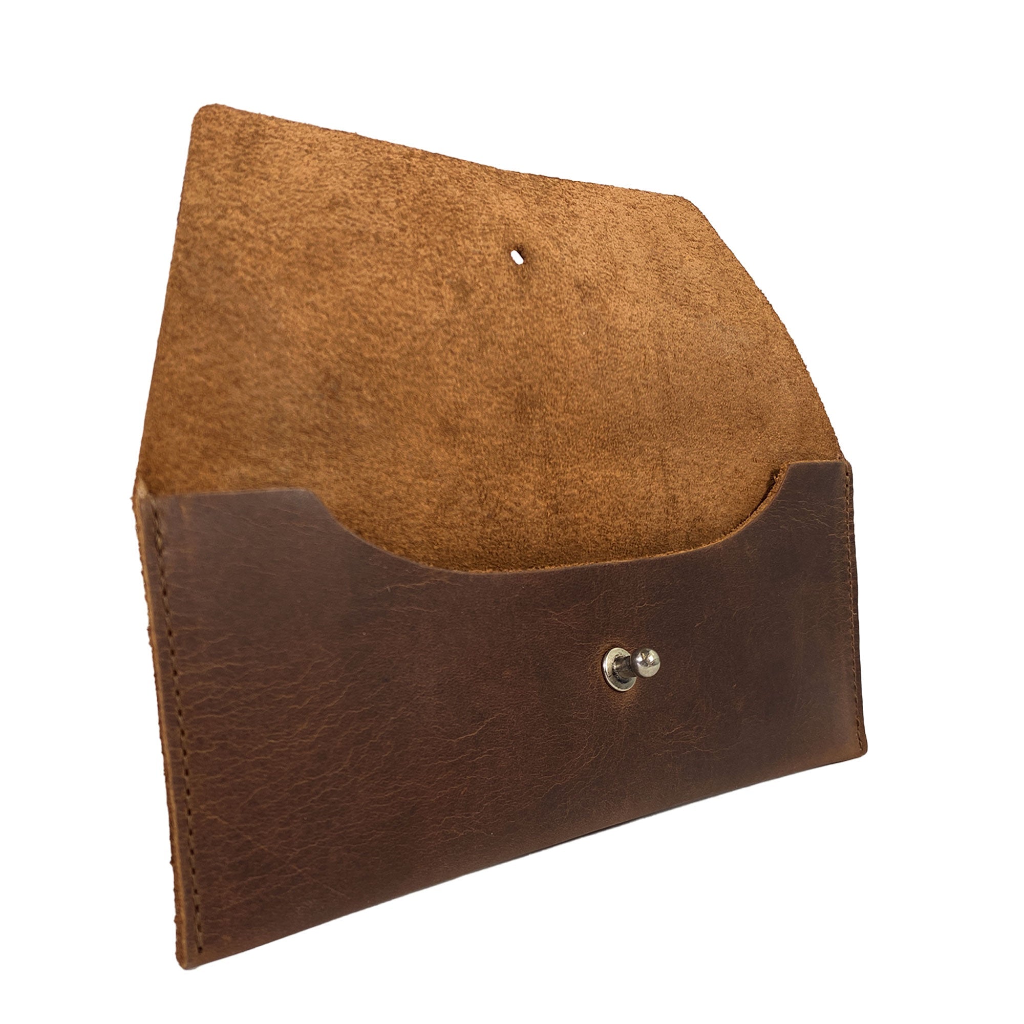 Side angle of Heather's Long Utility Pouch showcasing the interior storage. This stylish wallet is ideal for carrying and storing cash, coins, and cards, embodying a vintage, minimalist style made from full grain leather. Crafted through StockyardX's small batch production, each piece is hand cut, hand sewn, and fire branded—truly a handmade gem from La Antigua Guatemala.