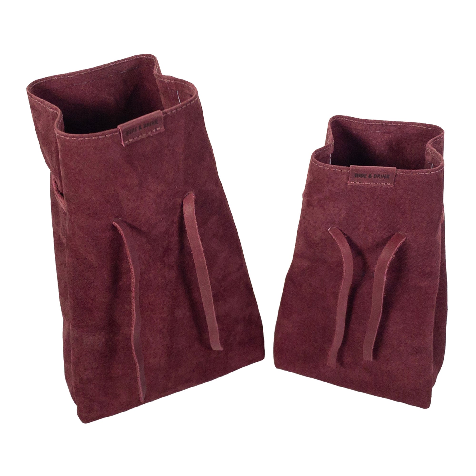 Hide & Drink's Drawstring Sack (2 pack) arranged with an array of items, highlighting how it effortlessly organizes everyday essentials. Drawstring Sack (2 pack) Handmade from Sheepskin and Full Grain Leather, StockyardX, Small Batch Production, Hand Cut, Hand Sewn, Fire Branded, Artisan, Handmade in La Antigua Guatemala & Oaxaca Mexico.