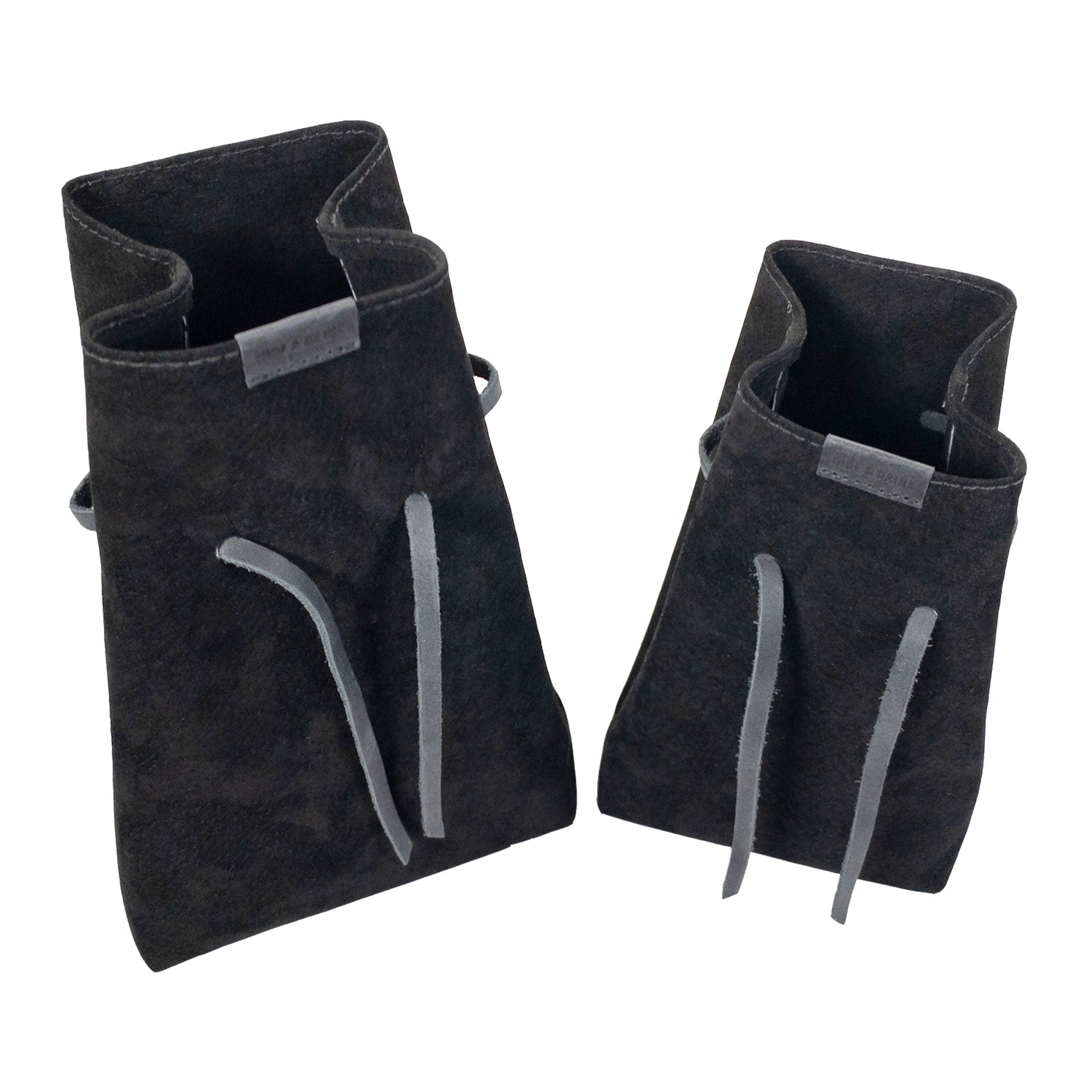 Hide & Drink's Drawstring Sack (2 pack) ready for organizing clutter, nestled against various items for everyday use. Drawstring Sack (2 pack) Handmade from Sheepskin and Full Grain Leather, StockyardX, Small Batch Production, Hand Cut, Hand Sewn, Fire Branded, Artisan, Handmade in La Antigua Guatemala & Oaxaca Mexico.