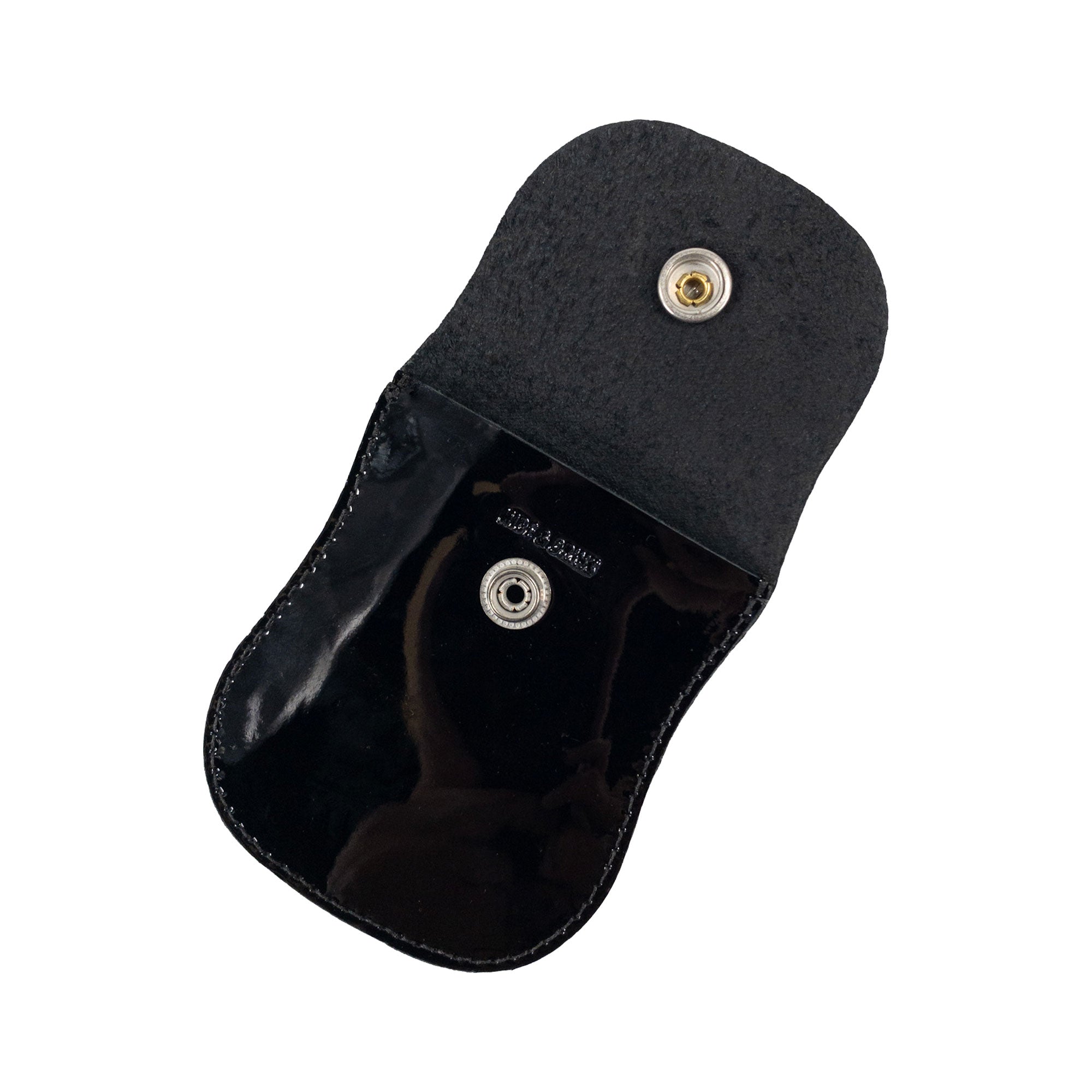 Interior view of the Curvy Coin Pouch by Hide & Drink featuring shiny black leather, emphasizing its dual functionality as an elegant pocket case for pennies and handcrafted travel accessory.