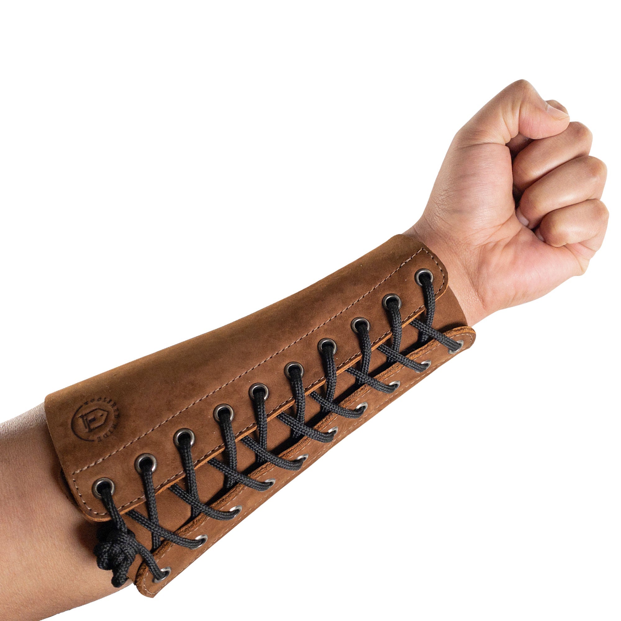 A hand wearing the Blacksmith Forearm Protector by Toolshed Hide, showcasing its fit and functionality. This artisan-made forearm protector is designed with full grain leather for heat resistance and comfort, ideal for both novices and professionals in blacksmithing.