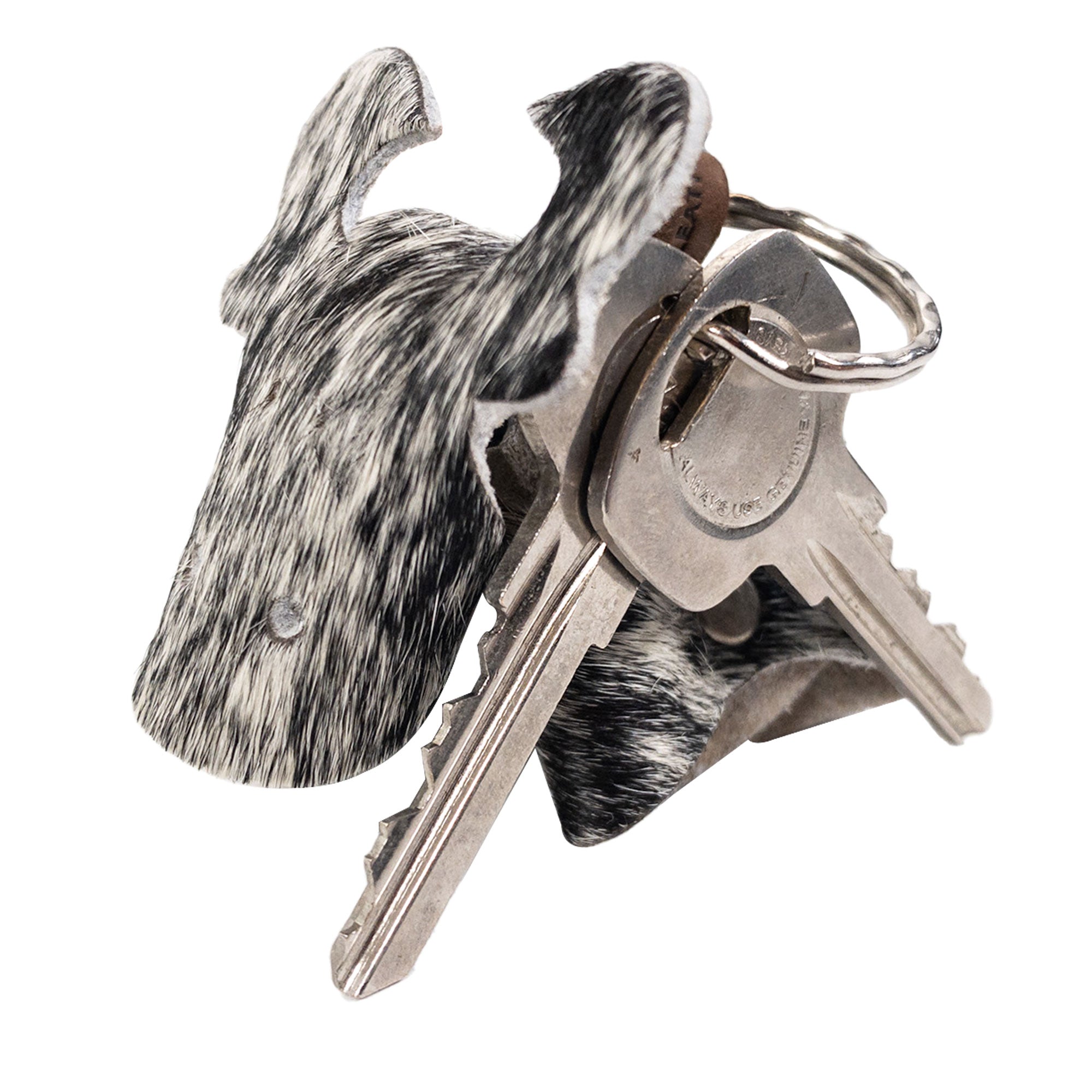Unique Cow Shape Keychain from Western Leather Works displayed with keys, made from Hair-On-Hide Full Grain Leather. This beautiful artisan piece reflects the hand cut and hand sewn craftsmanship characteristic of small batch production, a perfect blend of style and function from La Antigua Guatemala and Oaxaca Mexico.