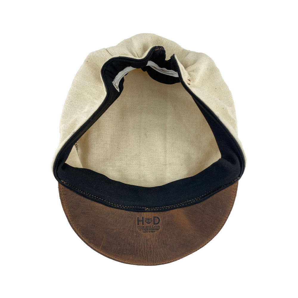 Interior view of the Manta Cotton Painter Cap by Hide & Drink, displaying its fine craftsmanship with Full Grain Leather & Natural Manta Cotton, made specifically for art enthusiasts. This Canvas Painter Cap showcases the values of small batch production, is hand cut, hand sewn, and fire branded, emphasizing artisan quality made in La Antigua Guatemala & Oaxaca Mexico.