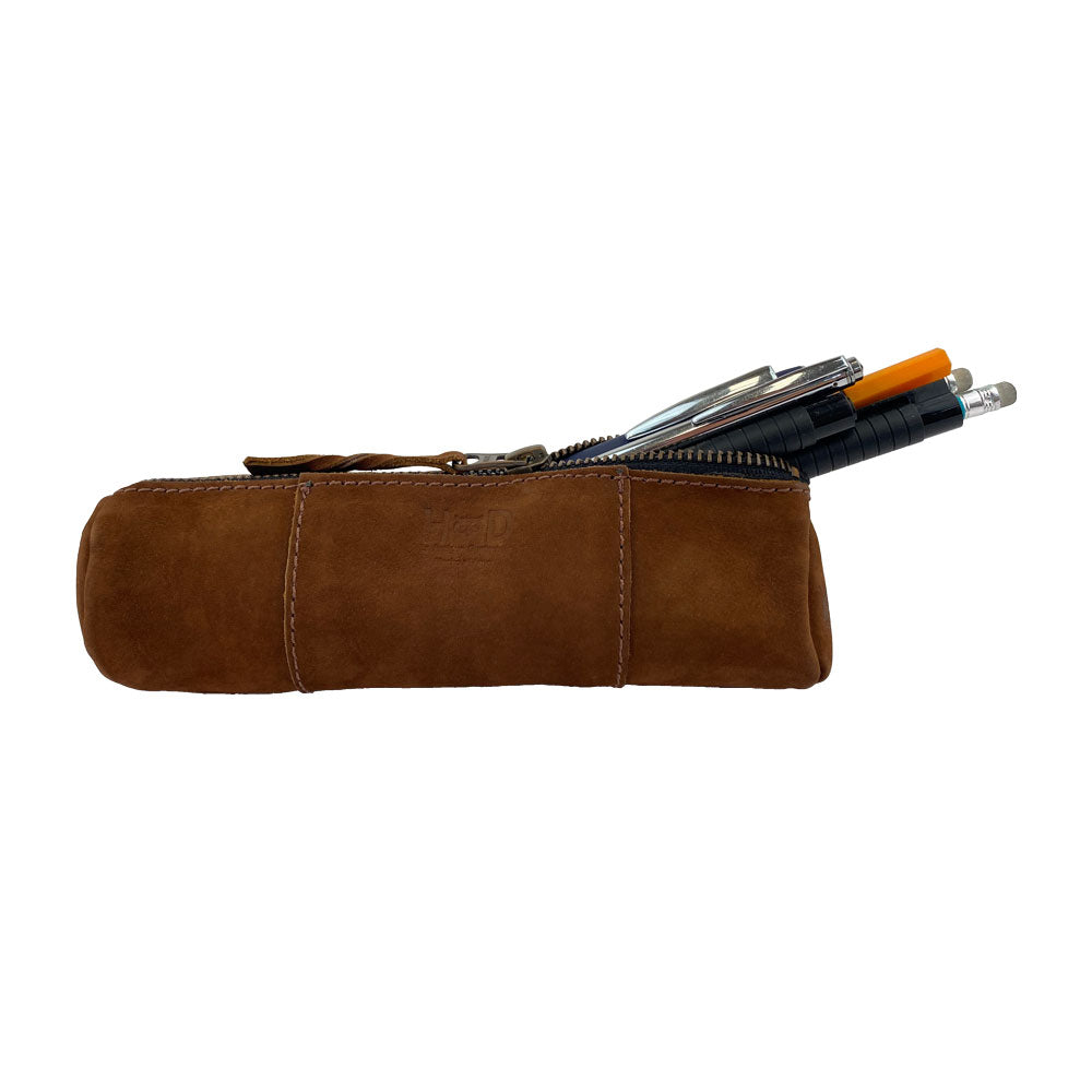 Utility Cylinder Case by Hide & Drink in a side view filled with various pens. This classic and artisan bag is made from Full Grain Leather, ideal for personal items and office supplies. Cylinder Case, Handmade, Rustic.