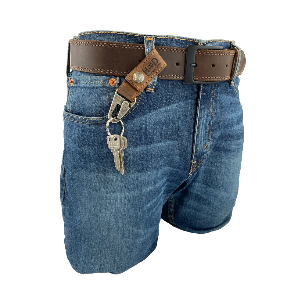 A stylish Key Ring Holder by Hide & Drink showcased on denim shorts, emphasizing its use in everyday life. Crafted from Full Grain Leather, this Key Ring Holder combines Small Batch Production, Hand Cut, and Hand Sewn techniques, featuring a Fire Branded design. It's a beautiful Artisan piece, Handmade in La Antigua Guatemala & Oaxaca Mexico.