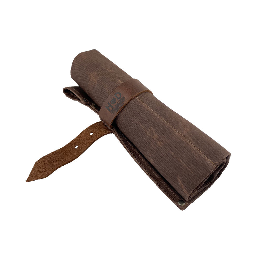 An attractive Large Tool Roll by Hide & Drink presented for practical use. This Portable Carry-On Pouch features 6 slots, making it suitable for woodworking tools organization. Crafted with durable waxed canvas and full grain leather variations, this artisan item showcases quality hand-cut and hand-sewn details, handmade in La Antigua Guatemala & Oaxaca Mexico.
