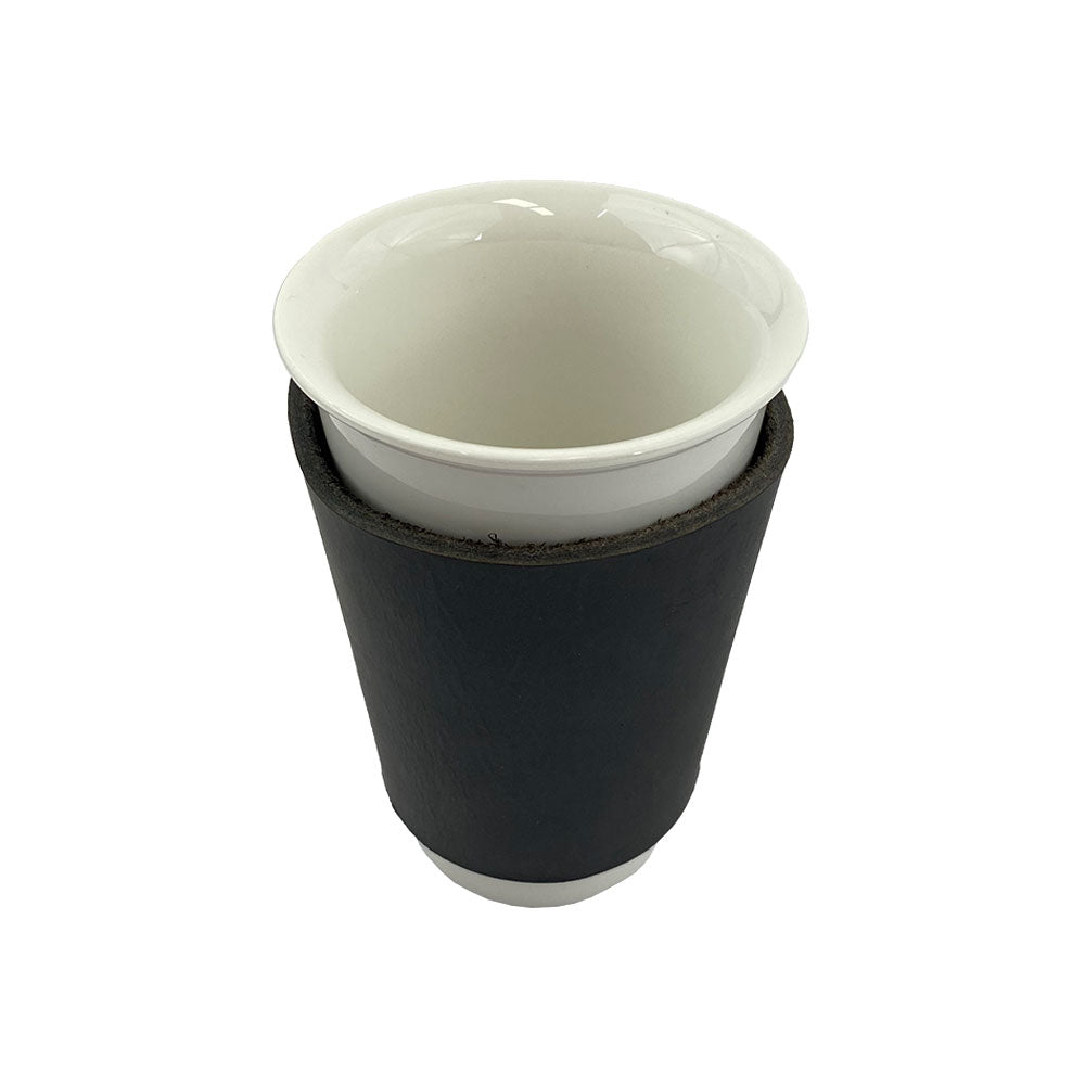 Another angle of the Hide & Drink black leather Pint Sleeve, showcasing its sturdy design and durable craftsmanship. This artisan piece provides natural temperature control and is a perfect gift for anyone who enjoys fine beverages, handcrafted in La Antigua Guatemala & Oaxaca Mexico.