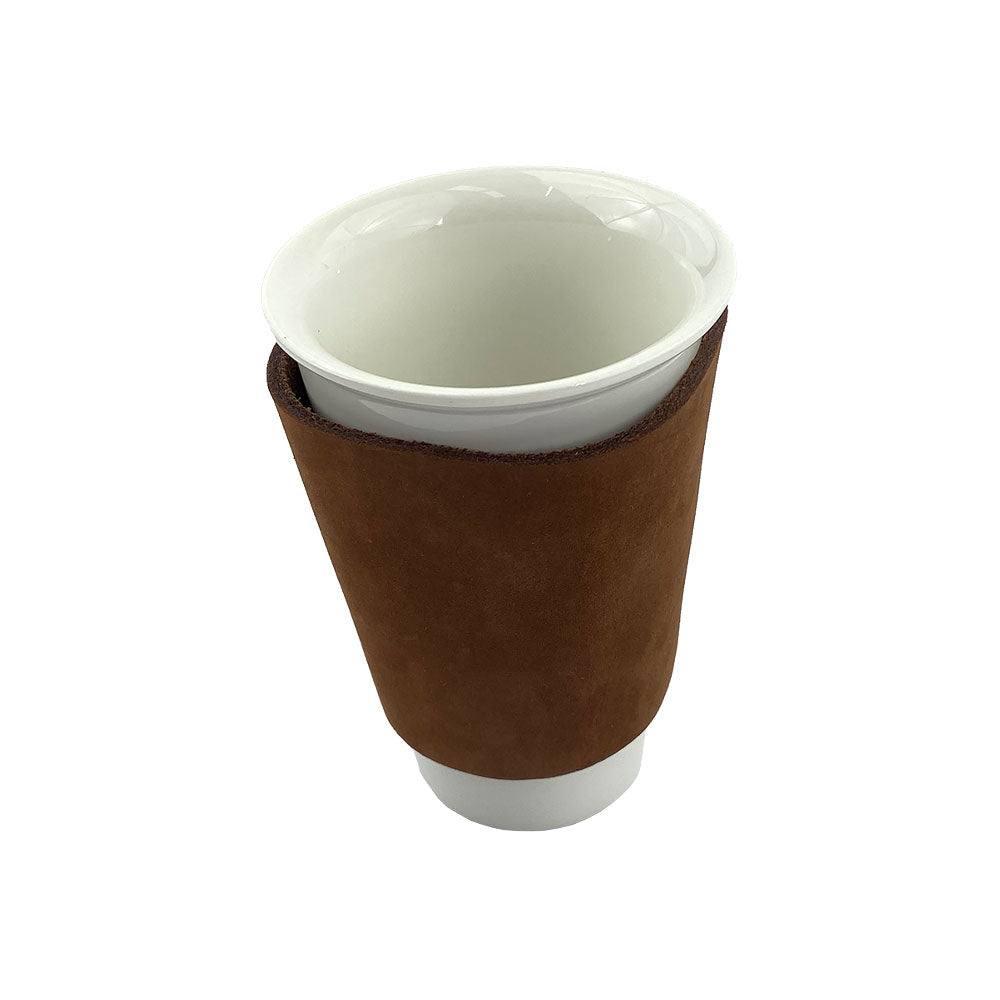 A detailed image of the brown leather Pint Sleeve from Hide & Drink showcasing its elegant design and sturdy build. The item is ideal for maintaining temperature and features brass metal rivets, demonstrating fine artisan craftsmanship from La Antigua Guatemala & Oaxaca Mexico.
