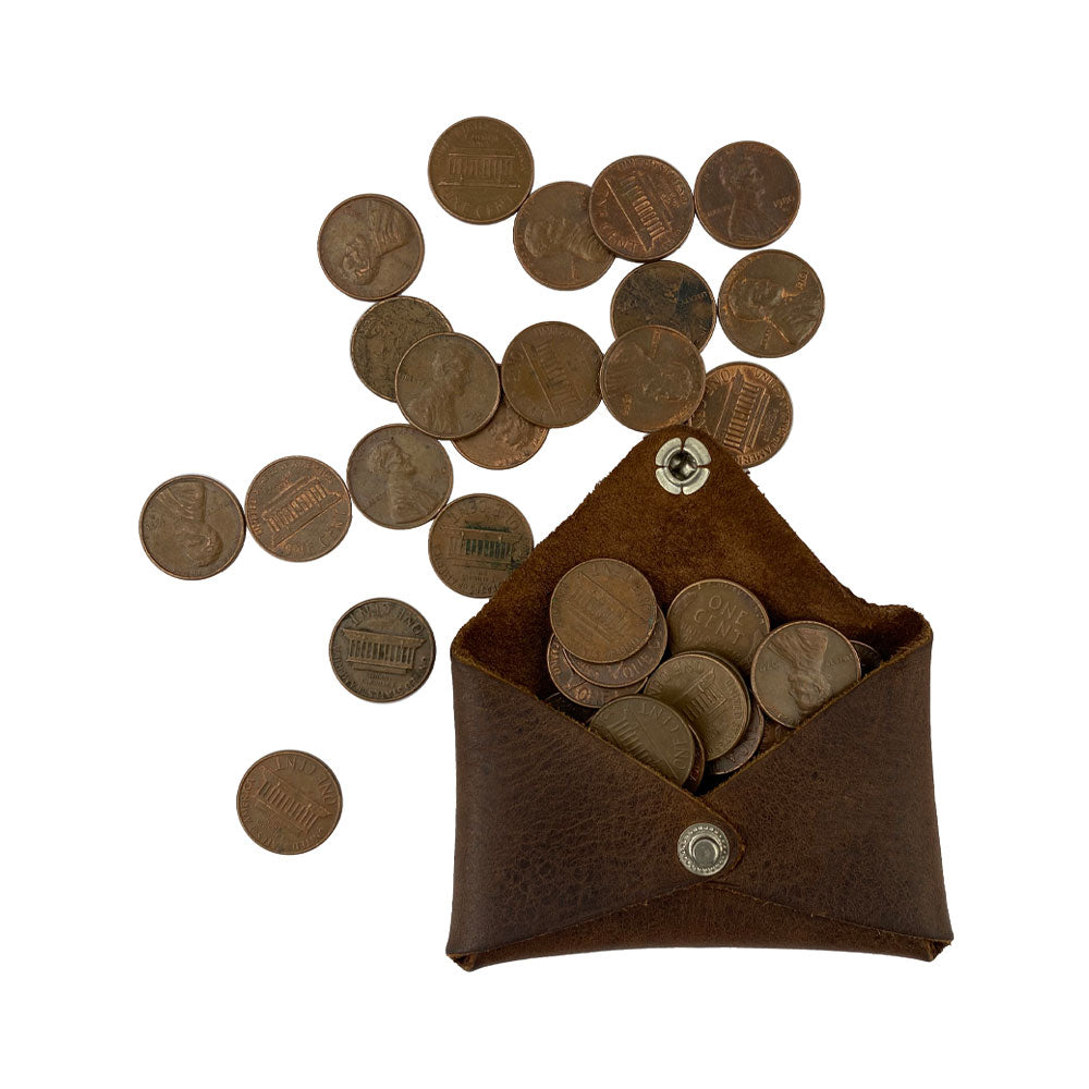 Hide & Drink Envelope Coin Case filled with assorted coins, demonstrating its practicality and charm. Made from high-quality full grain leather, this rustic leather case is handcrafted in La Antigua Guatemala & Oaxaca Mexico.