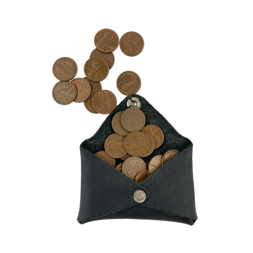 Hide & Drink Envelope Coin Case filled with coins, showcasing its design and utility. This piece made from full grain leather is a testament to artisan craftsmanship from La Antigua Guatemala & Oaxaca Mexico.