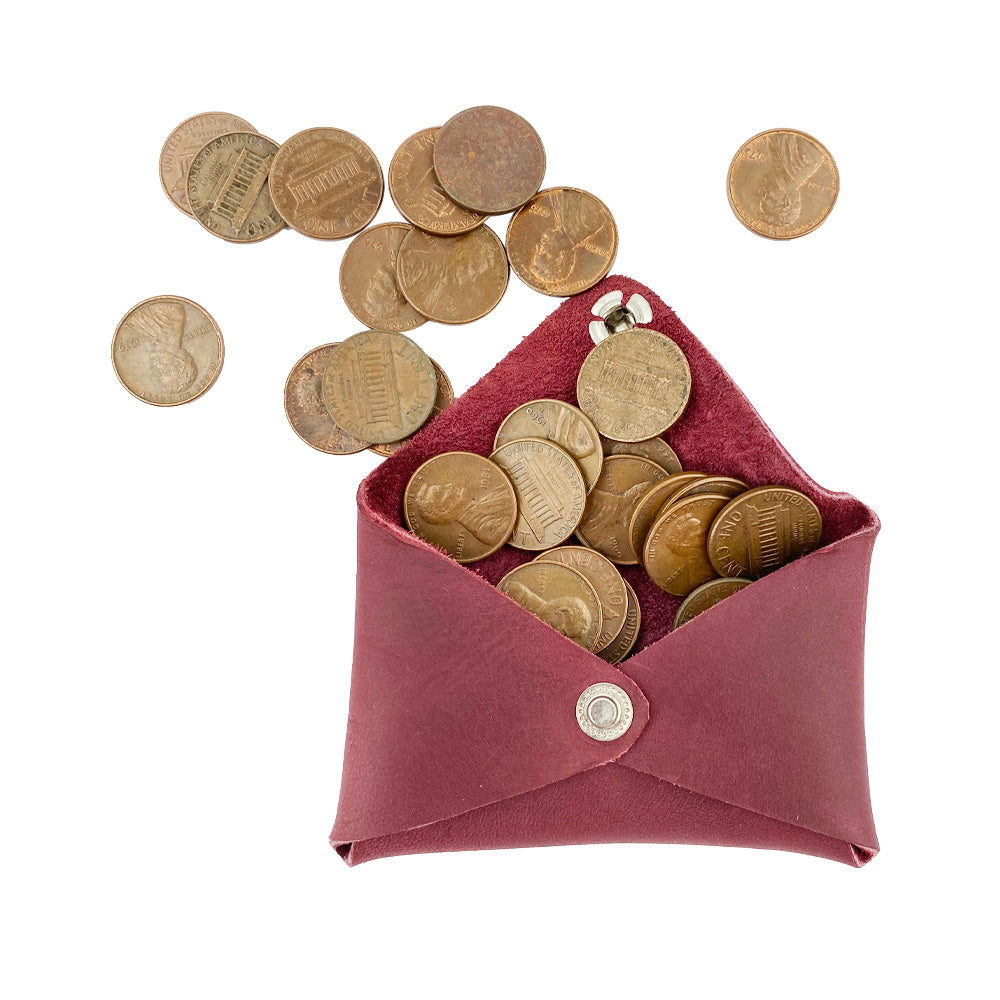 Hide & Drink Envelope Coin Case filled with coins, showcasing its functionality and charm. This handcrafted item is made from high-quality full grain leather, representing artisan excellence in La Antigua Guatemala & Oaxaca Mexico.