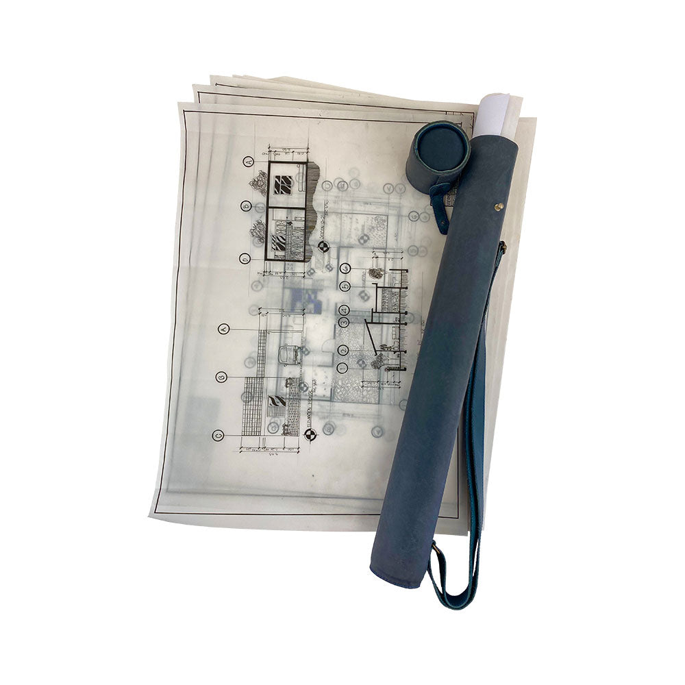 Hide & Drink's Blueprint Tube (A2 Paper Size) displayed with architectural plans in black leather. This full grain leather document storage tube features an adjustable strap, perfect for professionals, showcasing StockyardX's artisan quality and small batch production, handmade in La Antigua Guatemala & Oaxaca Mexico.