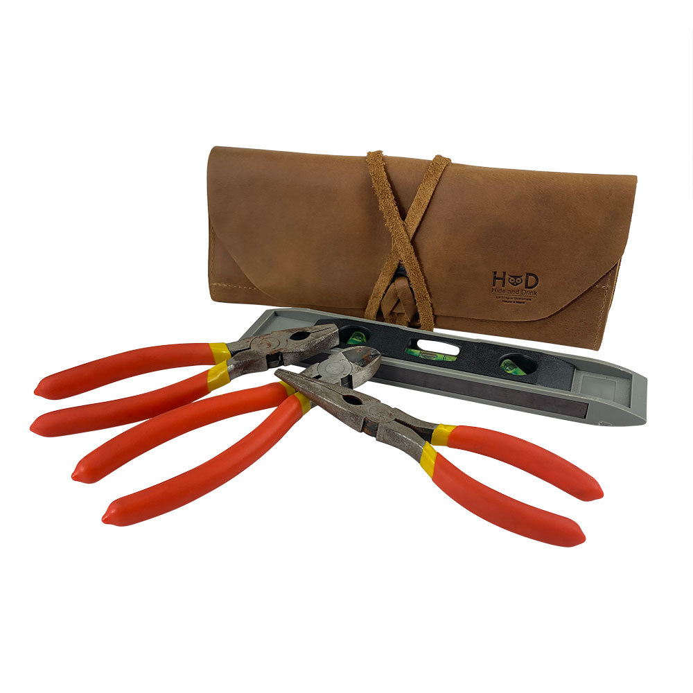 Hide & Drink Tool Roll features a classic small tool roll-up bag with 10 slots, designed from high-quality full grain leather. This portable carry-on pouch is a must-have woodworking tools organizer, perfect for workshop storage needs. Hand cut and sewn by artisans in La Antigua Guatemala & Oaxaca Mexico.
