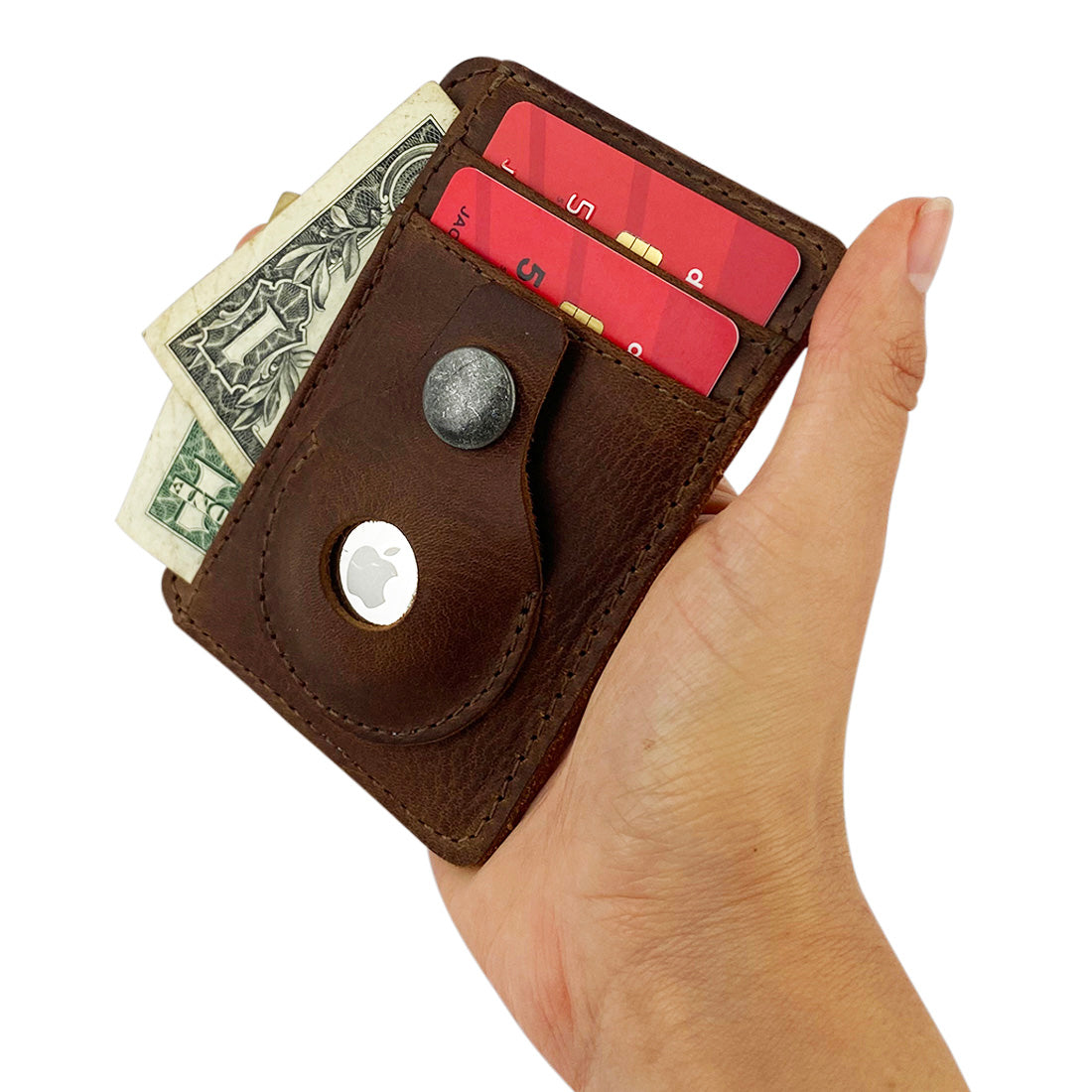 A hand holding the AirTag Vertical Card Holder by Hide & Drink filled with cards and cash, illustrating its practicality in Full Grain Leather. This handmade item, crafted through small batch production, highlights the skill of artisans in La Antigua Guatemala & Oaxaca Mexico, with hand cut and hand sewn features.