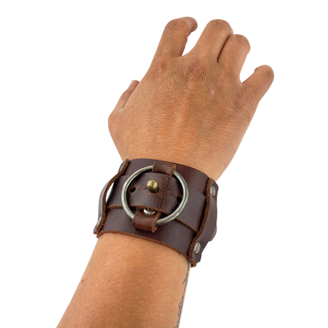 Hide & Drink Wristband model worn on a wrist, illustrating how the leather accessory complements authentic style. This Wristband with Ring Decoration Full Grain Leather, part of StockyardX's selection, highlights small batch production's craftsmanship. Hand cut, hand sewn, and fire branded, this piece is a testament to artisan skill from La Antigua Guatemala & Oaxaca Mexico.