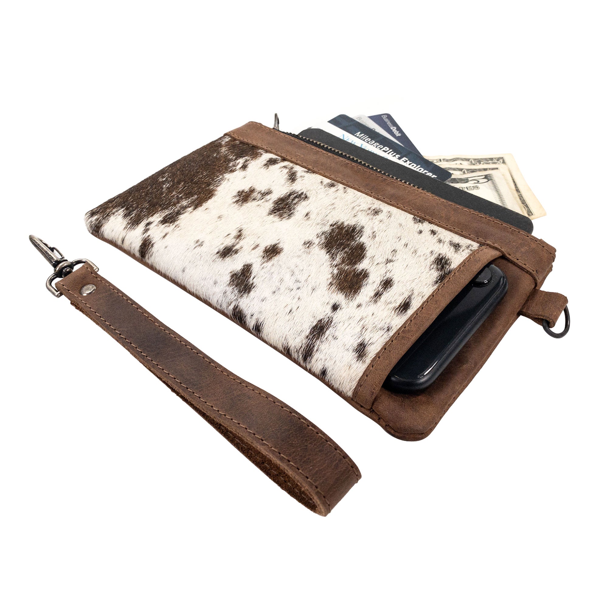 Wristlet Clutch Bag from Western Leather Works showing its hair-on-hide exterior and contents. This rectangular wristlet clutch handbag blends Western style and full grain leather, ideal for everyday use. Expertly handcrafted in La Antigua Guatemala.