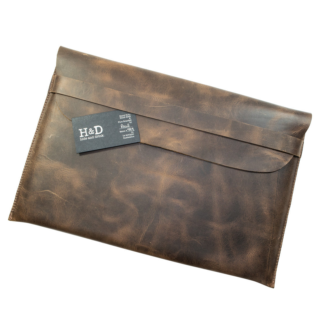 The Tablet Slim Case by Hide & Drink neatly packaged with its branding tag. This full grain leather sleeve provides a stylish and protective home for iPad 2 & iPad 3. Made using artisan methods such as hand cutting and sewing, this case is a product of small batch production, handcrafted in La Antigua Guatemala & Oaxaca Mexico, perfect for those who appreciate quality.
