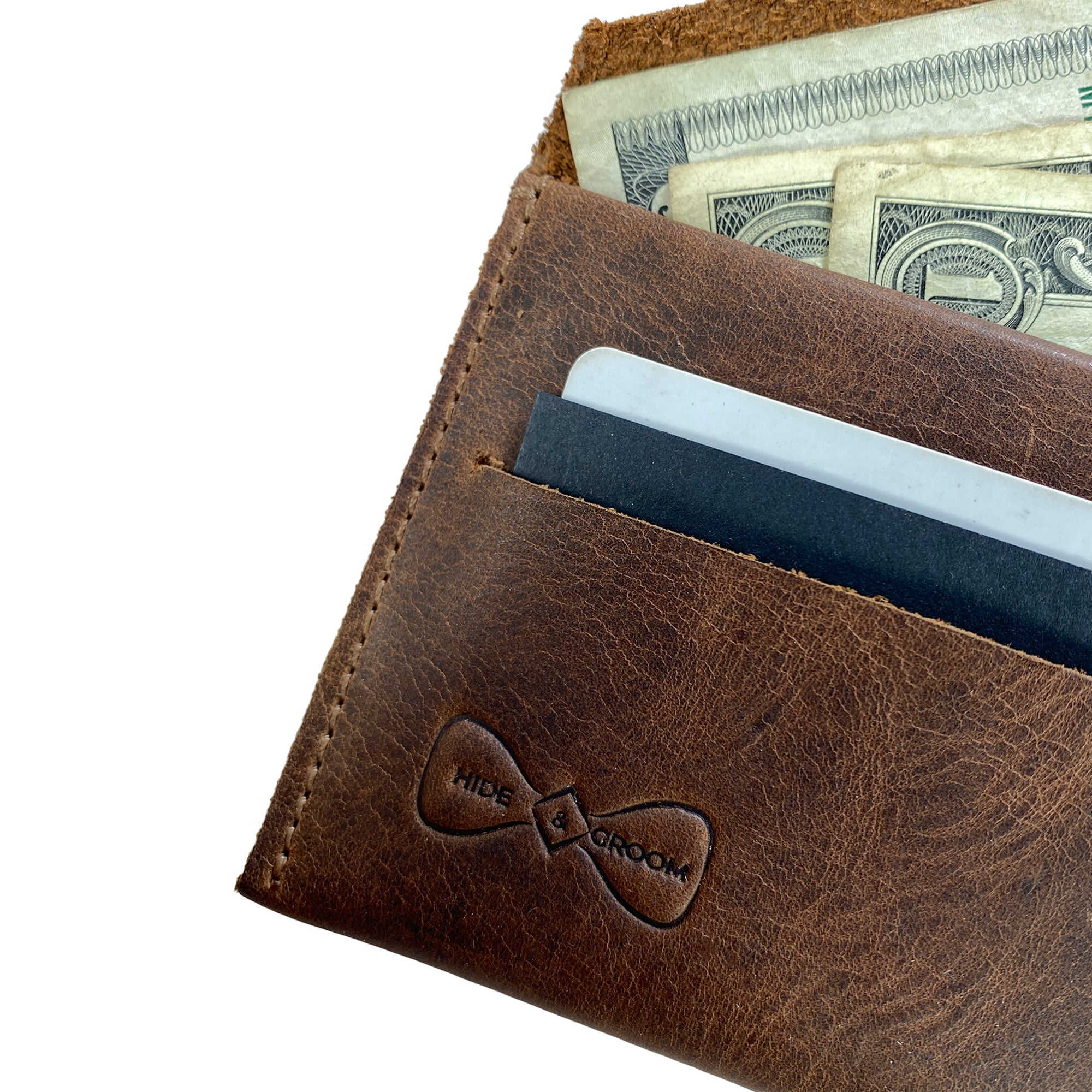 Close-up view of the Hide & Groom Minimalist Wallet showcasing its full grain leather texture and ample storage for cards and cash. Designed to be stylish and practical, this wallet is handcrafted in La Antigua Guatemala. Minimalist Wallet - Business Card & Money Holder, Stylish Compact Money Organizer, Full Grain Leather, StockyardX, Small Batch Production, Hand Cut, Hand Sewn, Fire Branded, Artisan, Handmade in La Antigua Guatemala & Oaxaca Mexico.