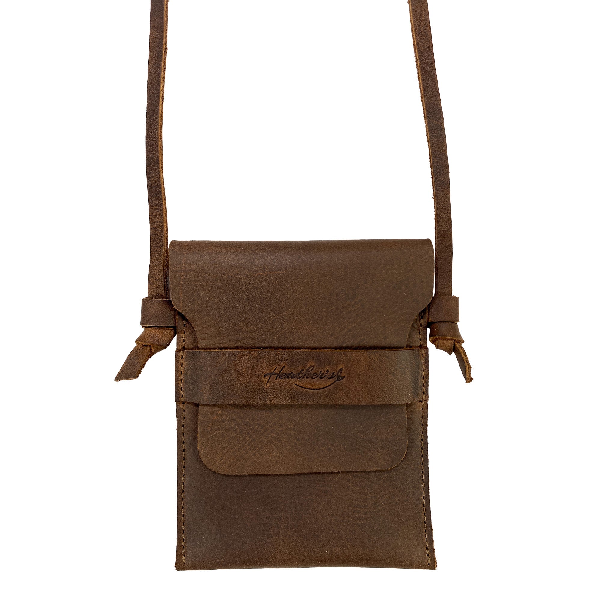 Mini Travel Bag by Heather's shown from the front with a secured flap. This Mini Travel Bag Handmade from Full Grain Leather acts as a classic organizer, coin pouch, and storage case for ID, credit cards, and cash. StockyardX, Small Batch Production, Hand Cut, Hand Sewn, Fire Branded, Artisan, Handmade in La Antigua Guatemala & Oaxaca Mexico.