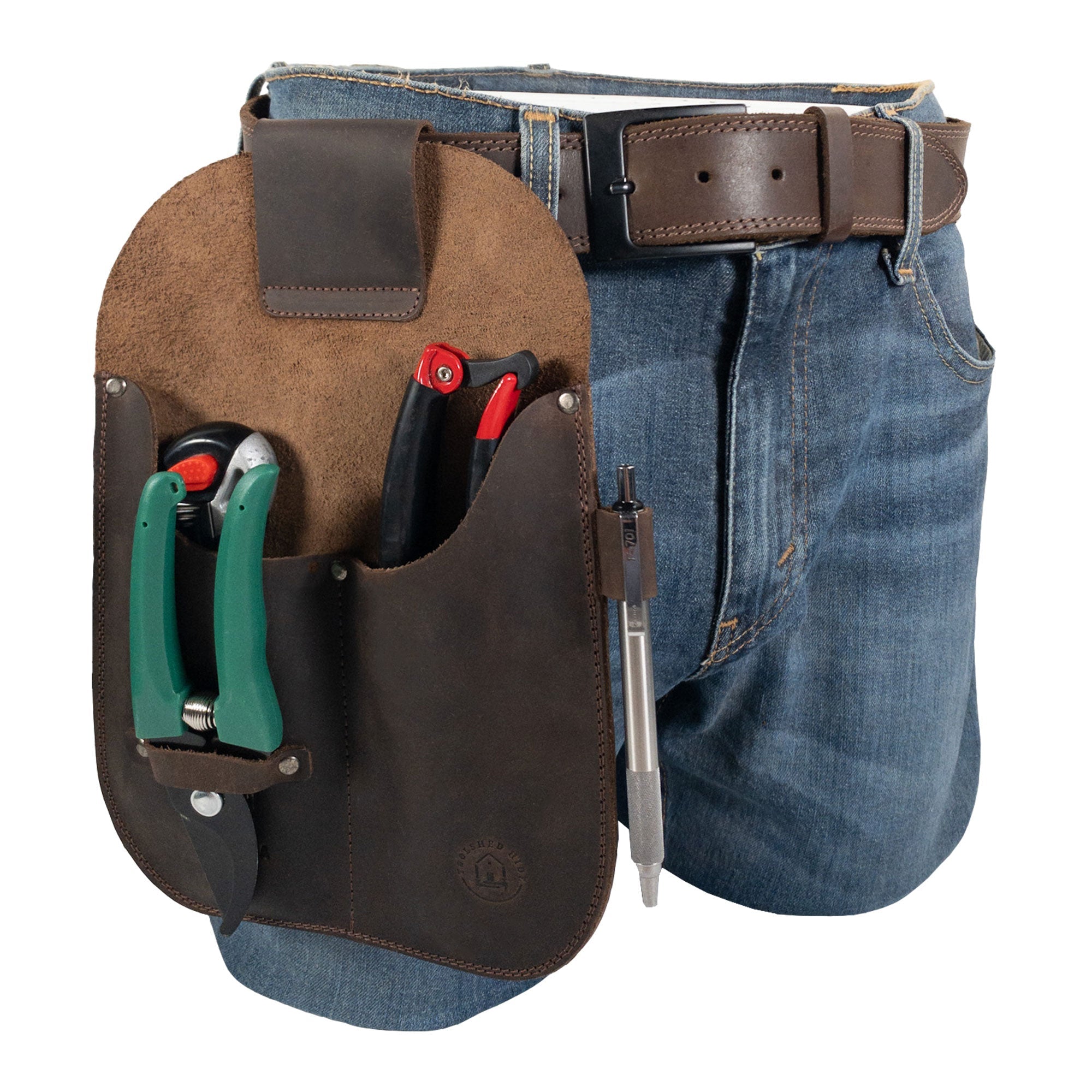 Gardening Tool Holder by Toolshed Hide worn on a belt, highlighting its practical design for gardeners. This stylish Gardening Tool Holder is crafted from full grain leather, emphasizing small batch production, with hand cut, hand sewn elements and authentic fire branded artisan quality. Handmade in La Antigua Guatemala & Oaxaca Mexico.