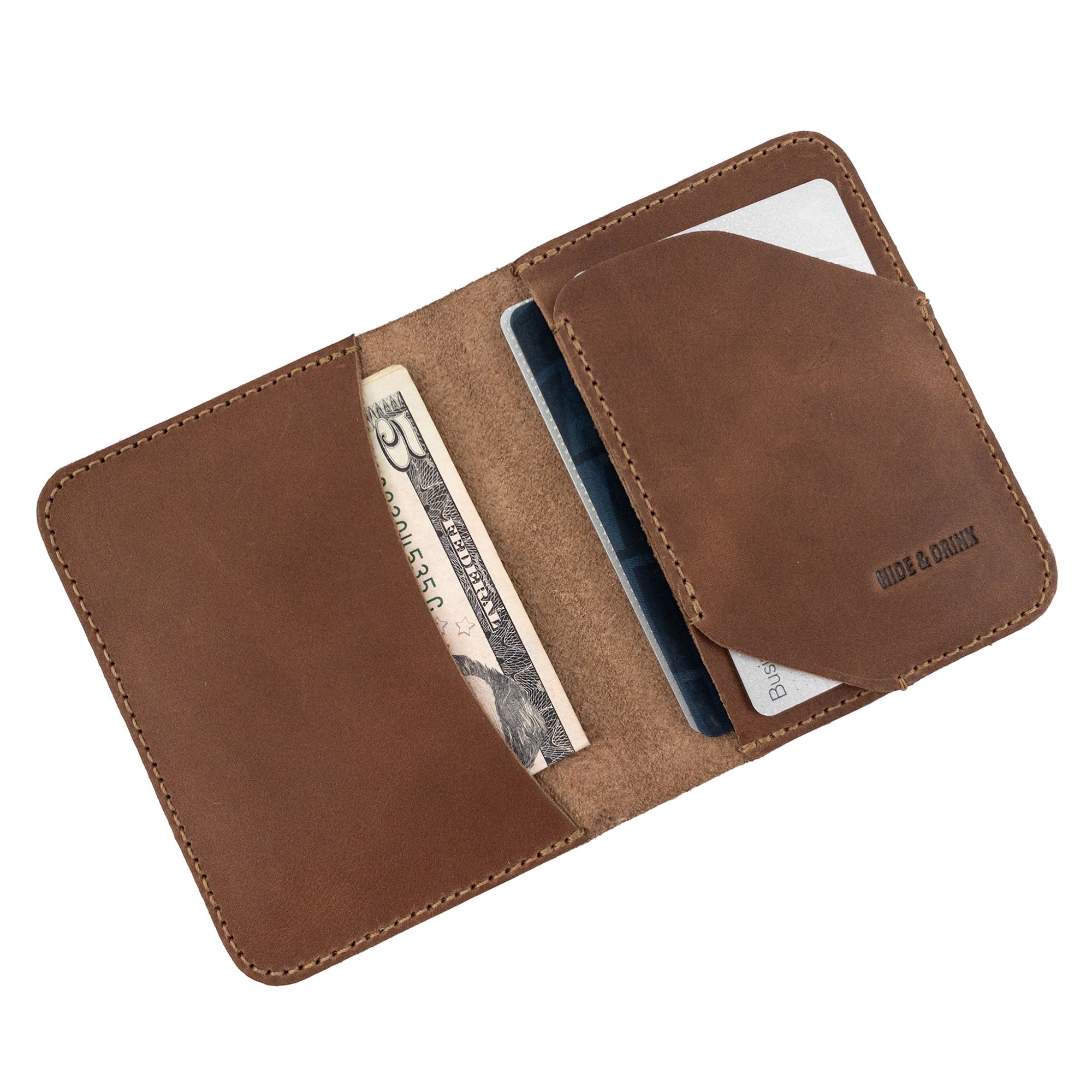 Inside view of the brown Bi-Fold Card Wallet Diagonal by Hide & Drink, showcasing its spacious layout for cash and cards, handcrafted from high-quality full grain leather.