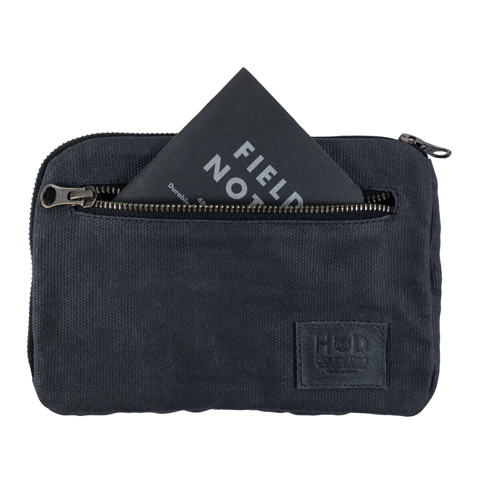Hide & Drink's dark brown Zipper Gear Pouch featuring a Field Notes card in the front pocket, emphasizing its practical use and artisan quality, made from water resistant waxed canvas.