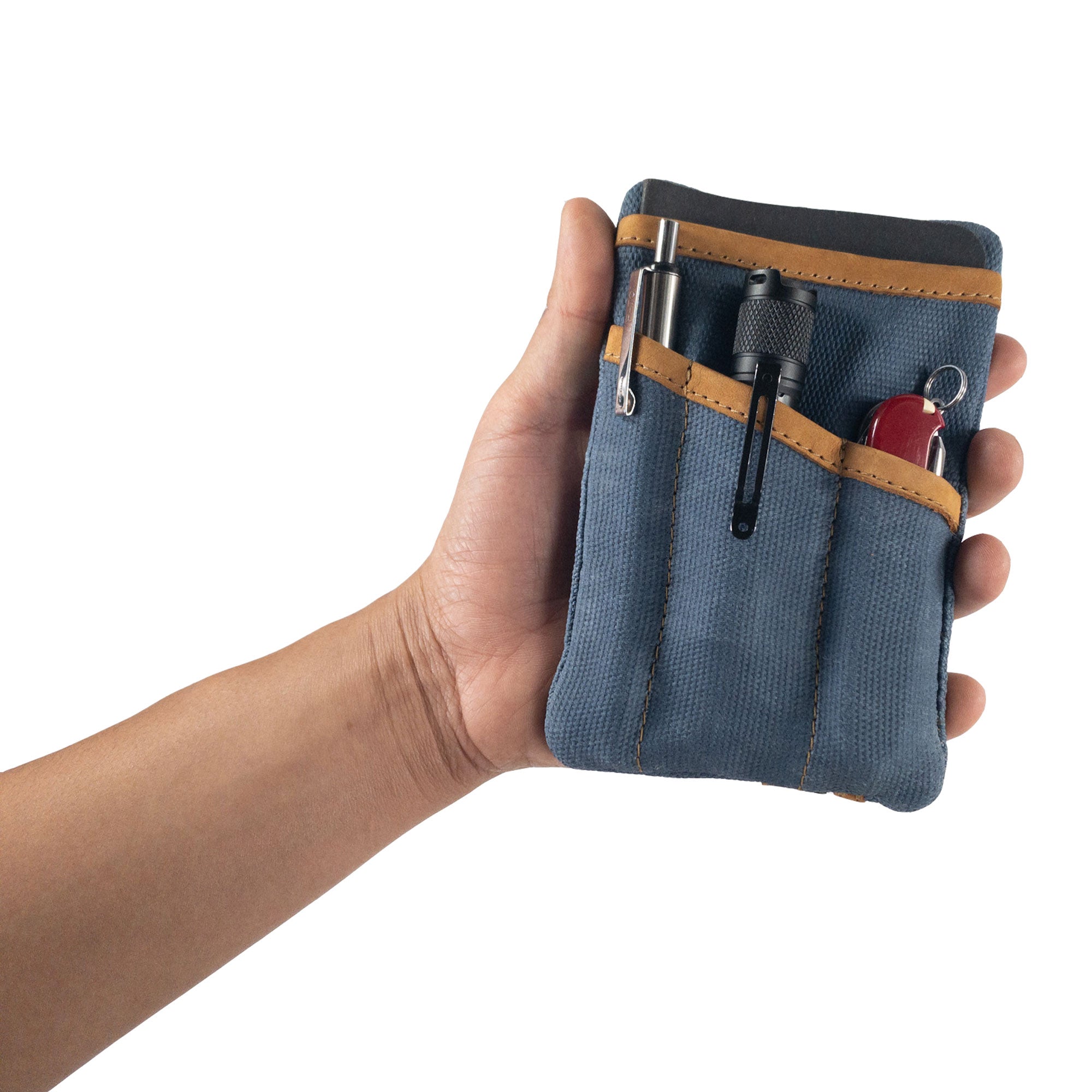 Person holding the grey Multi-tool Pocket Pouch by Hide & Drink, displaying its multifunctional design and artisan quality.