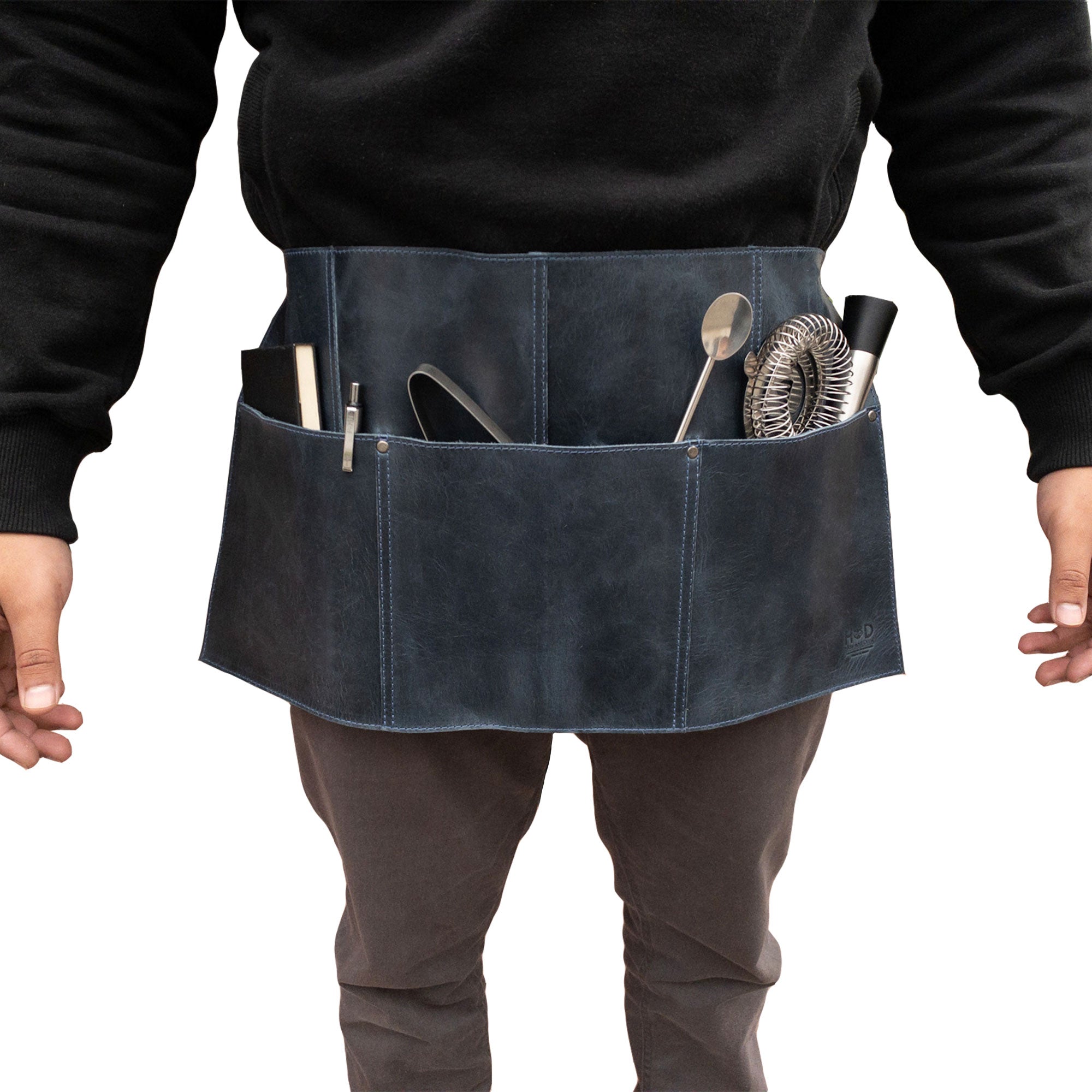 Detail view of the black Hide & Drink Barista Leather Waist Apron, highlighting its riveted pockets and vintage appeal, made from full grain leather, crafted expertly in La Antigua Guatemala & Oaxaca Mexico.