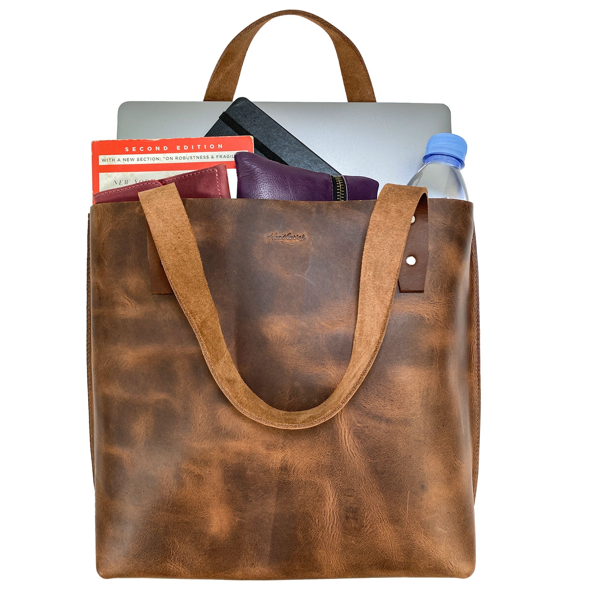 Heather's Minimalist Shoulder Bag packed with everyday items, illustrating its roomy design. This Minimalist Handbag Vintage Purse with Handle is both functional and elegant, made from high-quality Full Grain Leather, perfect for shopping and travel.