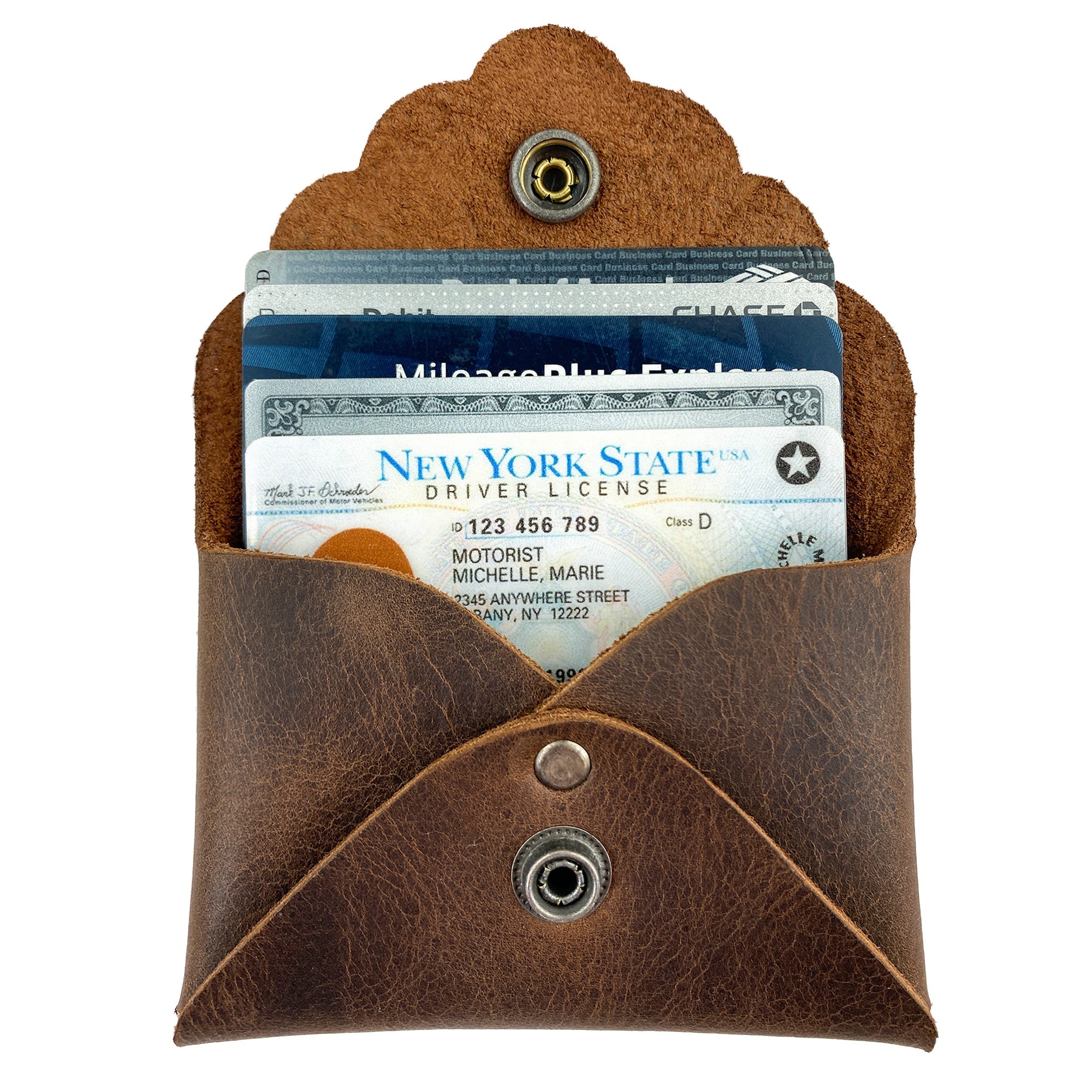 The Stylish Envelope by Heather's with cards inserted, demonstrating its practicality as a classy organizer. This compact storage solution for debit and credit cards is made from premium full grain leather, crafted through small batch production with meticulous hand cutting and sewing, fire branded for quality, and handmade in La Antigua Guatemala & Oaxaca Mexico.