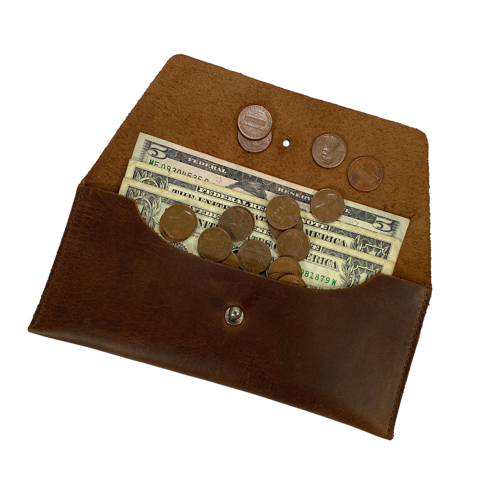 Heather's Long Utility Pouch filled with cash and coins, perfect for stylishly carrying essentials. This minimalist clutch made from full grain leather combines functionality with artisanal craft, part of StockyardX's small batch production from La Antigua Guatemala. Hand cut and hand sewn, this fire branded wallet is a great addition for anyone.