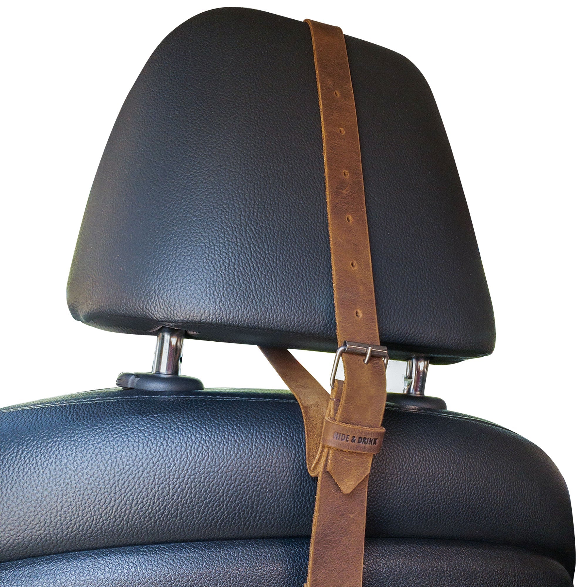 View of the Hat Hanger by Hide & Drink on a car seat, demonstrating its adjustable height and minimalist style. This travel accessory made from full grain leather is perfect for organization while on the go, reflecting handmade quality from La Antigua Guatemala & Oaxaca Mexico.