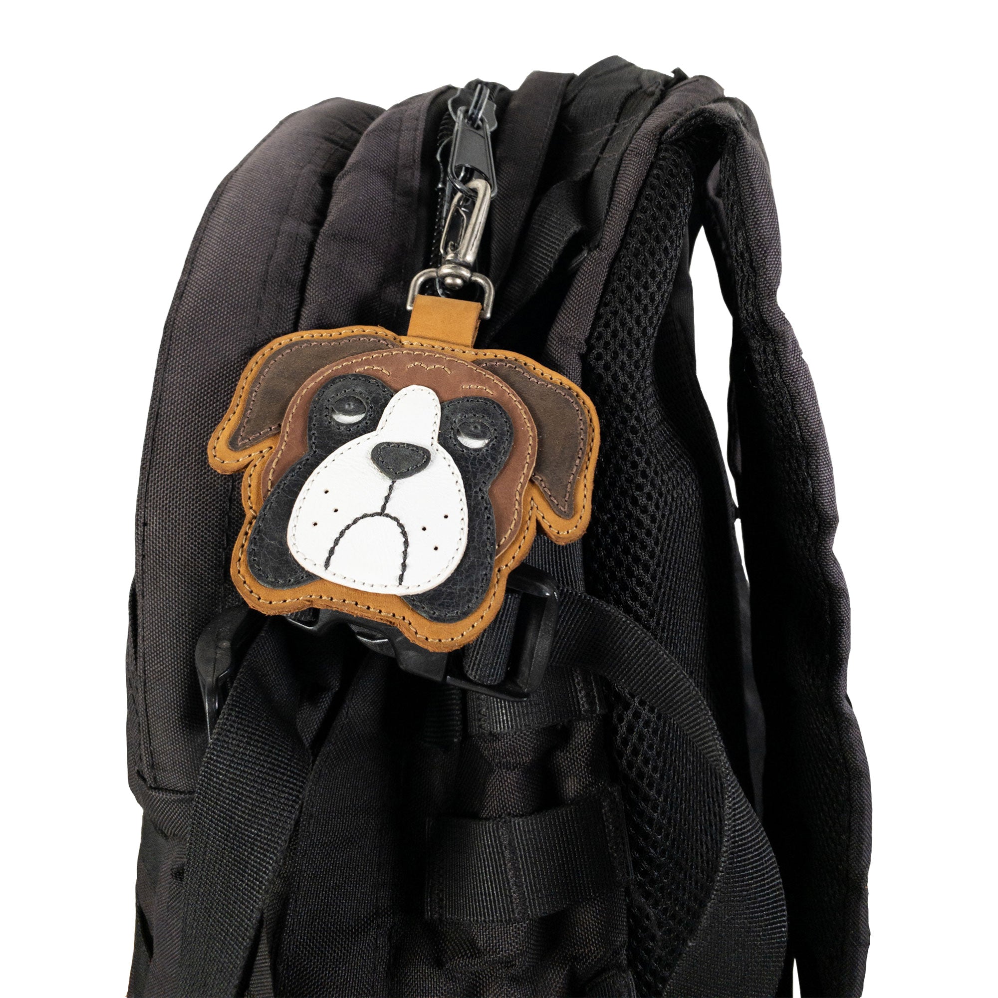Boxer Face Charm by TACO DOG displayed on a black backpack clip, made from durable Full Grain Leather. A charming artisan accessory made through small batch production, hand cut and hand sewn methods to highlight craftsmanship. Handmade in La Antigua Guatemala & Oaxaca Mexico.