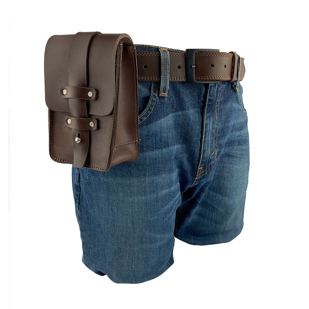 Worn Bartender Fanny Pack by Hide & Drink on denim shorts, demonstrating its convenient size and easy attachment. Crafted from thick full grain leather, this artisan-made fanny pack is perfect for bartenders, handmade in La Antigua Guatemala.