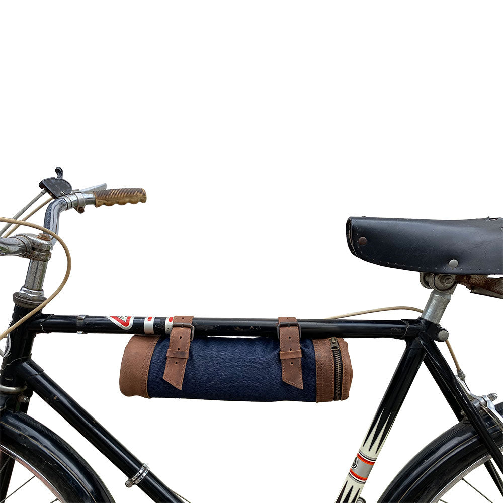 Dimensions of the Navy Blue Bicycle Tube from Hide & Drink displayed next to a common wine bottle size, showcasing its practical design. This Bike Pack Tube is an essential for cycling enthusiasts who appreciate artisan quality. Handmade in La Antigua Guatemala and Oaxaca Mexico.