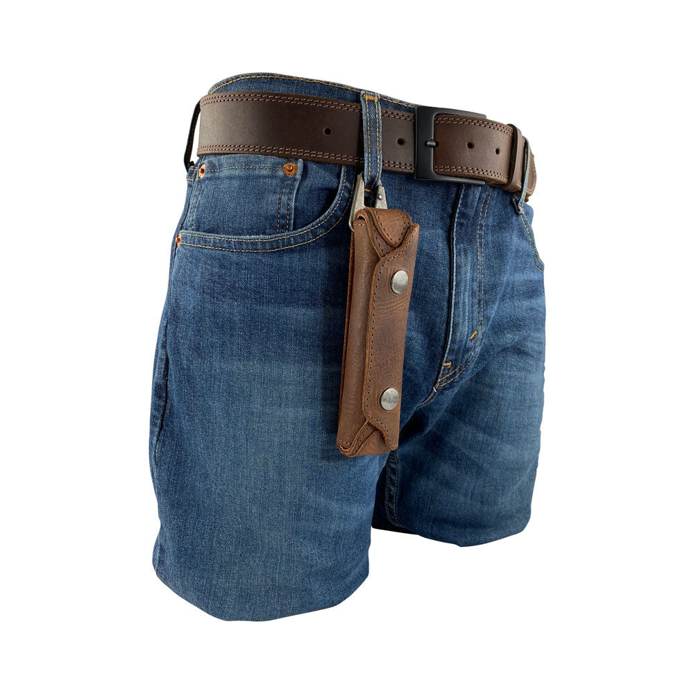 Harmonica Case from Hide & Drink attached to a belt, showcasing its functionality and convenience. This full grain leather instrument cover is perfect for musicians on the go. Handmade in La Antigua Guatemala with artisan craftsmanship, it makes a great addition to any musical toolkit.