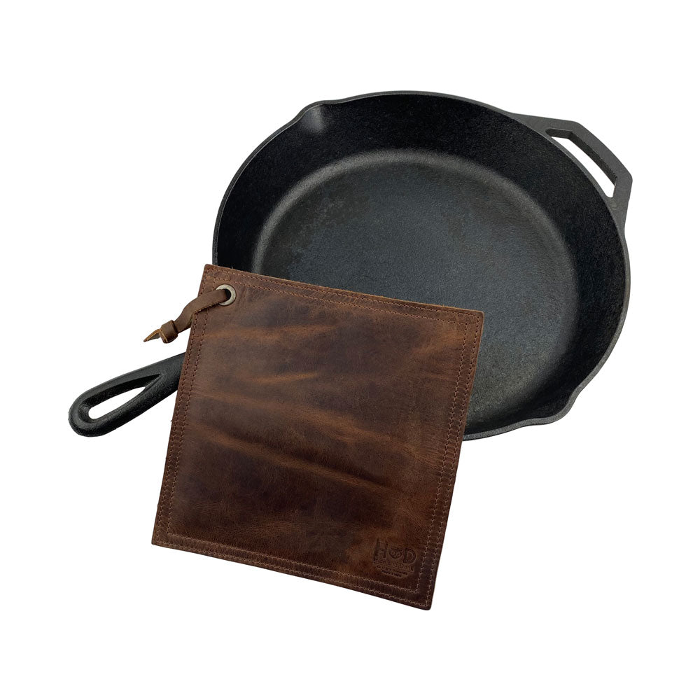 Hide & Drink Pot Pad featuring a business card, highlighting its artisan touch. This handmade rustic leather pot pad is double-layered and perfect for hot items.