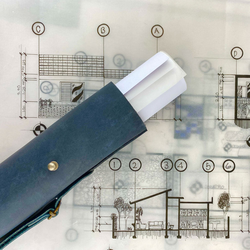 Hide & Drink's Blueprint Tube (A2 Paper Size) in black leather, featuring an adjustable strap for easy carrying. This durable document storage tube emphasizes artisan craftsmanship and small batch production from StockyardX, handmade in La Antigua Guatemala & Oaxaca Mexico.