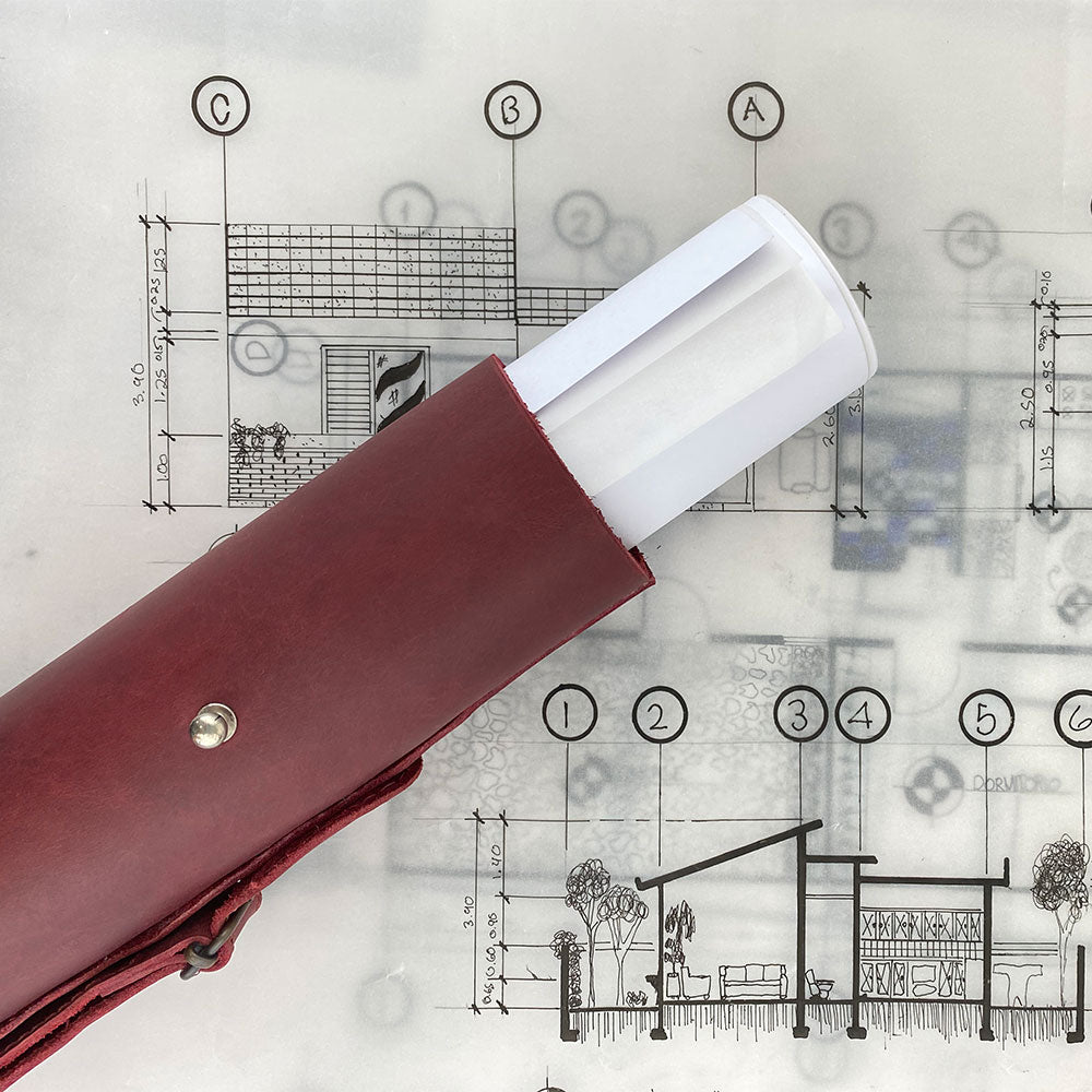 Hide & Drink's Blueprint Tube (A2 Paper Size) in olive green leather, ideal for carrying architectural documents. This durable document storage tube features an adjustable strap and showcases artisan craftsmanship with StockyardX's handmade quality from La Antigua Guatemala & Oaxaca Mexico.