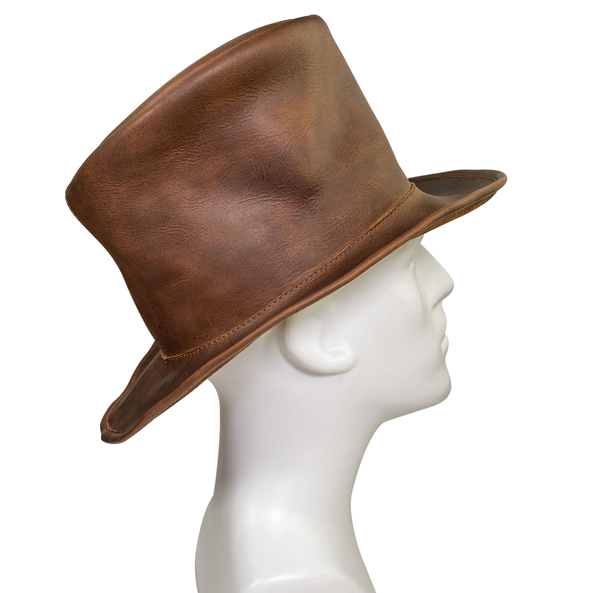 A side angle view of the Hide & Play Top Hat featuring a classic design and warm leather tones while on a mannequin, highlighting its stylish silhouette. This Mad Hatter Top Hat is perfect for cosplay, Halloween, performances, films, and shows. The hat, made from full grain leather, showcases small batch production, hand cut, hand sewn expertise, and fire branding from artisans in La Antigua Guatemala and Oaxaca Mexico.